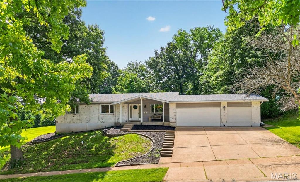Introducing this special 4-bedroom ranch home in the award-winning Parkway School District! Thoughtfully renovated, this home delivers comfort and functionality in style. Gorgeous hardwood floors flow through the bright and open floor plan. A welcoming front porch leads into an entryway centered between the dining room and living room. The beautifully appointed kitchen has 42" custom cabinets, granite countertops, stainless steel appliances, and a breakfast bar and is adjacent to the family room with a wood-burning fireplace. This main living space is ideal for daily living as well as for hosting special occasions and gatherings. The main floor primary suite offers a walk-in closet and spa-inspired bath with double sinks and an oversized shower. Three additional generously sized bedrooms share a beautifully updated full bath. Enjoy the private back patio and large, level lot which is surrounded by mature trees and made for summer evenings. The 3-car garage has plenty of room for cars and additional storage storage. The expansive unfinished lower level offers exceptional potential for future living space, a gym or workshop. Major 2018 updates include roof, gutters, fascia, soffits, vinyl siding, all new windows, kitchen, baths & hardwoods. Additional updates include a water heater and HVAC system.