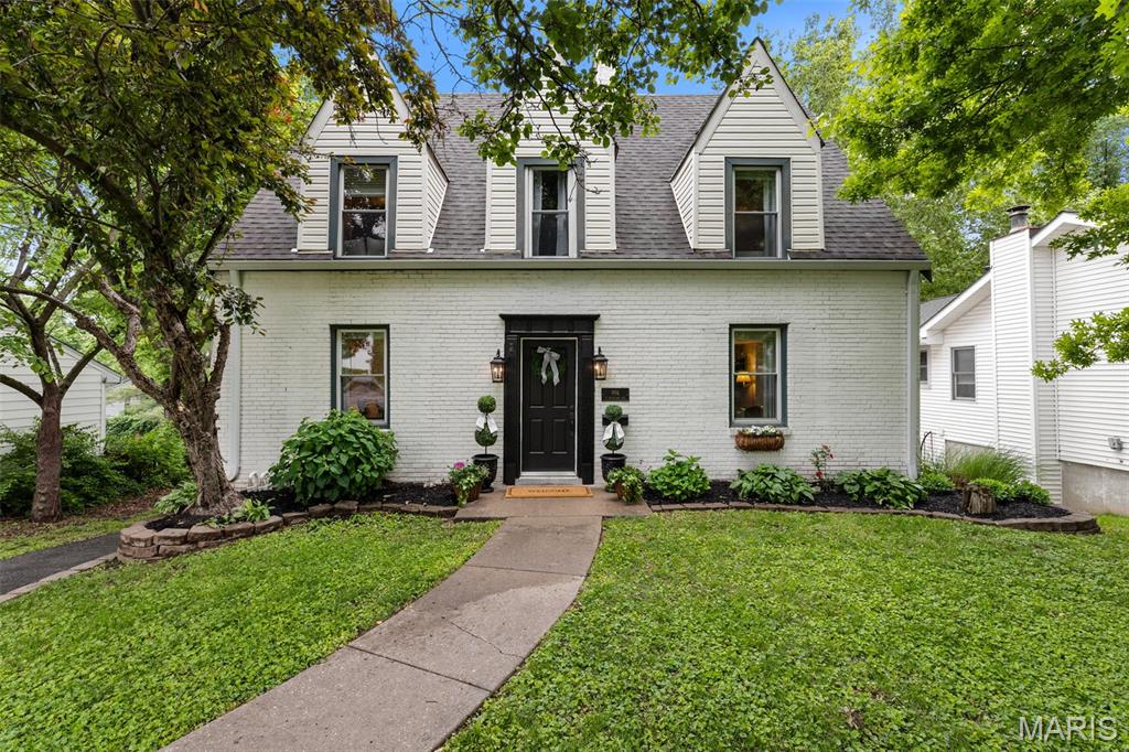 Nestled on a picturesque, tree-lined street, this stunning white brick Cape Cod perfectly blends classic architectural character with sophisticated modern updates. From the moment you pull up, the undeniable curb appeal and manicured landscaping welcome you home. Inside, you’ll find an inviting floor plan designed for both comfortable living and elegant entertaining. The home features 3 spacious bedrooms and 2 1/2 bathrooms including a rare and sizeable primary ensuite. The home also boasts beautiful hardwood floors throughout, high-end finishes such as stainless-steel appliances and granite countertops and updated systems to ensure worry-free living. The home also has ample storage on all three floors and a main-floor laundry room, another coveted rarity in historic Kirkwood. The airy, open feel is enhanced by large windows that frame views of the lush greenery outside. The charm extends to the backyard, where you’ll find a peaceful oasis in the large maintenance-free composite deck, perfect for morning coffee or summer BBQs. The mature trees, flowers and fenced-in backyard create a truly serene setting you won’t want to miss. Take the party downstairs to the finished basement that is perfect for watching the big game and cheering on your favorite team! Lastly, enjoy the very best of Kirkwood living seeing you are just minutes away from: the vibrant Downtown Kirkwood shops and restaurants, the historic Kirkwood Farmers Market and award-winning schools and beautiful local parks. Don’t miss your chance to own this turnkey gem. Schedule your private showing today. Note: agent is related to the seller.