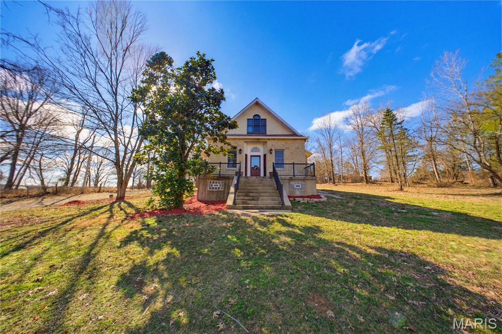 Nestled on 5.3 acres with a year-round creek, this beautifully remodeled farmhouse offers 4 bedrooms, 4 bathrooms, and an inviting kitchen with new granite countertops and is fully furnished with all new stainless steel appliances, refrigerator, stove, & dishwasher. The spacious living and dining areas feature 11-foot ceilings, tall windows, and a charming wood-burning fireplace in the dining room. A delightfully sunroom with tons of windows that leads out to a gorgeous front porch that is perfect for early morning coffee & bird watching. The lower-level family room is remodeled and has a sparkling new bathroom. On the main level, there is the primary suite, which includes an ensuite bath for convenience and privacy. A newly added laundry/bathroom combo offers extra convenience directly off the back entrance. Upstairs, you'll find 3 bedrooms, a full bath, and a versatile room for a study or nursery. There is a large attic that provides potential for more living space or home storage. Outside, there is a detached two-car garage that is perfectly located off the back porch. The acreage around the home is perfect for horses, and the property teems with wildlife. Just minutes from Elephant Rocks, Johnson Shut-Ins, and Council Bluff, this rare home offers endless possibilities as a peaceful retreat or an Airbnb investment property. Homes like this rarely come available in this area. Come view this private property with in walking distance to downtown Belgrade.