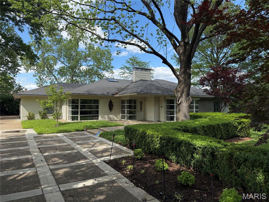 Rare opportunity to own a one-of-a-kind re-imagined 1950s ranch home, situated on a beautiful .35-acre lot in the desirable Richmond Hills subdivision – Top Rate Ladue Schools, Reed Elementary. From the moment you drive up to this home, you will realize just how special it is.

Walk through the front door, into the glass entry foyer, and you will know you are home & you won’t stop saying WOW!! This 3 bedroom, 3.5 bath showplace with over 3700 sqft of living space will leave you speechless. No detail was overlooked, and every finish was beautifully executed.

The main floor boasts an extremely functional floor plan, designed for today’s living and entertaining, with huge commercial grade, custom windows in every room, as well as multiple skylights, which fill this home with a tremendous amount of natural light, inviting the outside in!!

You will find a formal dining room, a separate living room, with artistic gas fireplace, a lovely powder room, a gourmet eat-in kitchen with an abundance of built-in custom cabinetry, custom countertops, and built-in laundry, opening to the fantastic light filled hearth room, overlooking the professionally landscaped backyard.

If that is not enough, there is a super charming, cozy reading nook / library, with 2-story ceiling, 3 skylights, floor to ceiling built-in bookshelves, built-in designer couch & custom fireplace, a fantastic primary suite with huge custom organized walk-in closet, and a wall of built-ins to compliment it, leading to the luxury bath, with custom tiled walk-in shower, jetted tub and large vanity, 2 additional nice sized bedrooms, and the 2nd full bath, complete the main level.

Other features include high efficiency HVAC, hardwood floors, recessed lighting throughout, alarm & irrigation systems, beautifully landscaped yard, an oversized, attached 2-car garage, and custom / artistic designed driveway, just to name a few.

The professionally finished walkup lower level features a spacious rec room with 2 sitting areas, and the 3rd full bath, still leaving plenty of room to expand its’ finished footprint, while still leaving a significant amount of unfinished storage.

Sip your morning coffee on the covered front porch, or the rear patio, in your private oasis, or take a walk through the parklike neighborhood. This home is amazing for entertaining family and friends!

Location could not better - near major hospitals, and convenient to shopping, restaurants, county parks, as well as close by to many of St. Louis’s finest schools, and easy access to major highways.