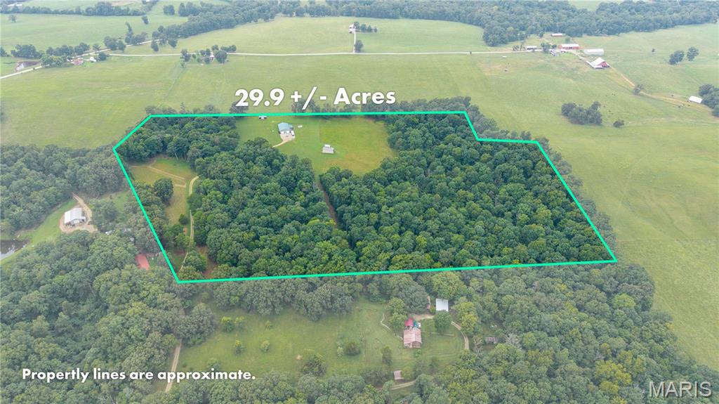 Located just inside Bollinger County you'll find this beautifully maintained 30 acre parcel of land with a shop house. This property has been meticulously cared for. There are about 25 acres of woods (some marketable timber) with the rest being cleared. If you love the outdoors you will appreciate the serenity and privacy. With an added wildlife pond there is wildlife galore! A 30 amp hookup is present for your camper or RV as well as a storage shed. Inside you will find a plenty of natural light and tons of additional storage in the attic space. In addition to electric heat, there is a wall mounted propane heater which reduces the electric bill in the winter and solves the problem of no heat in case of power outages. There is an additional wall mounted propane heater inside the insulated garage.