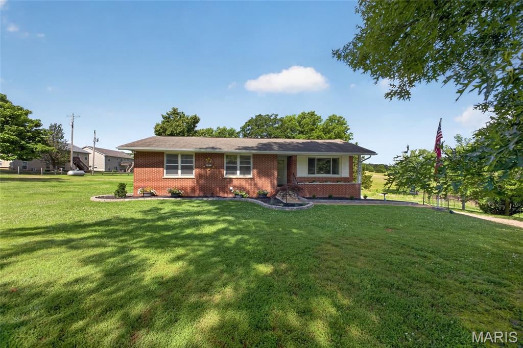 Country feel with stunning lake views-right inside city limits.

Existing loan may be ASSUMABLE for qualified buyers, subject to lender approval. The assumable loan interest rate is significantly below prevailing market rates.

This 4 BED, 2 FULL and 2 HALF BATHS on approximately 1.03+/- ACRES offers the perfect blend of privacy, space, and convenience. The open living and dining area features engineered wood flooring, abundant natural light, and a beautiful wood-burning stone fireplace. Sliding doors lead to a spacious back deck.

The PRIMARY SUITE showcases exposed beams, a walk-in closet, and a private bath, along with abundant natural light from a large Andersen window. Three additional bedrooms are located on the main level, plus the convenience of main-level laundry.

The unfinished BASEMENT includes a half bath and a tuck-under 2-car garage, offering excellent potential for additional living space, storage, gym or a workshop.

Recent UPDATES include a new HVAC system (2024), upgraded 50-gallon 36k btu propane water heater, and a new dishwasher (2025). The sellers have also updated light fixtures, remodeled a guest bedroom.

Outdoor features include a circle driveway with ample parking, plus a 50-amp RV hook up, perfect for guests or travel setups. Sellers also plan to solid stain the back deck.

The sellers plan to leave the lawn mower and select living room bookshelves for the new owner. 

Enjoy a peaceful setting with scenic water views while still being close to everything. Schedule your showing today.

Measurements are approximate.