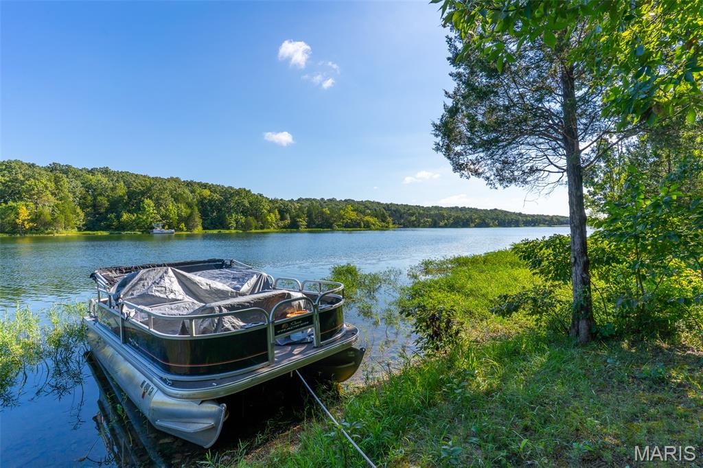 Are you looking to build your WATERFRONT dream home?  This Is It!  This double lot is in it's natural state and has a cleared path to the water with easy access to tie up your boat. Very secluded and nothing across the lake to view but more nature. This is a paradise for nature lovers and fisherman while still being near  town and a straight shot to St. Louis.  (approx 40 miles).  Bonus:  Golf Course within the community is another reason to say YES to this opportunity for lake life.
