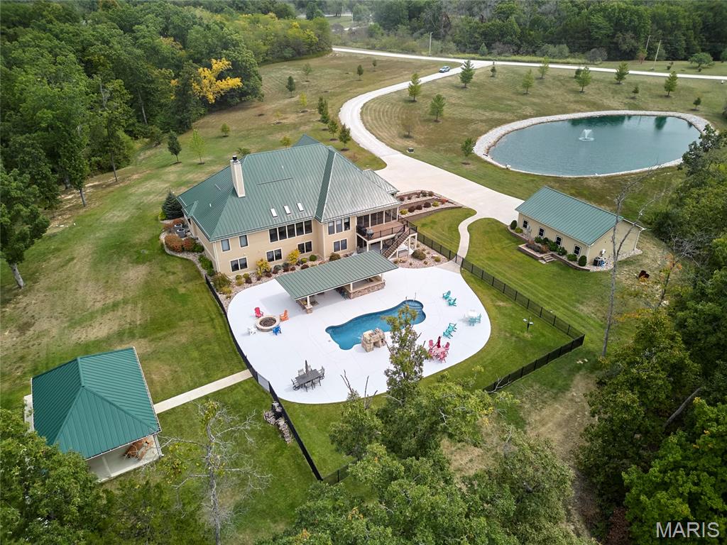 Come home to your own private retreat tucked away on 15 acres only 10 minutes from downtown Warrenton.  This 8 year young custom built Ranch offers over 6000 sq feet of living space along with an outside space that is perfect for entertaining & spending time with your family & friends. Main level offers large Great Room with stone fireplace, vaulted ceilings w/skylights,recessed lighting. Custom kitchen w/quartz countertops & backsplash, Main floor primary bedroom & Large master bath with dual vanities, walk in shower, large soaking tub. Laundry is on main level along with a HUGE bonus room/office that looks out at the fully stocked pond w/fountain. Lower Level offers 3 addl. bedrooms, full bath, family area & recreation room & plenty of storage space. Walk out to the HUGE patio area w/heated salt water pool, covered outdoor kitchen w/bar, Large pavilion, 3 car attached garage & an addl. detached heated garage, professional landscaping, Generac Generator, remote window shades on main level, sprinkler system, security system, metal roof on all structures, Hardie siding, Screened in porches on each level, covered composite deck, crown molding, solid wood doors, 7 inch baseboards. Large covered front porch.  
So many upscale finishings throughout this impeccable home! You will be IMPRESSED & This could be YOUR DREAM HOME!!