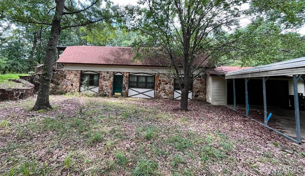 ?Located at 20524 Highway M in Belle, MO, this private oasis sits on roughly 4 to 5 acres of secluded land surrounded by lush greenery, framing rock walls, and special yard touches featuring floral and fauna. Designed with open yet private multi-level rooms connected by short steps, the home features a spacious yet cozy family room complete with a circulating fireplace to help offset heating costs, large and cozy bedrooms, and a kitchen equipped with a brand-new electric convection range and dishwasher. For outdoor living, you can greet the morning sunrise from a 23 x 8 front deck with coffee or tea, or unwind in the evening by watching the sunset from a 15 x 18 double deck featuring a pergola. Offering a quiet and peaceful retreat that is still close to town and schools