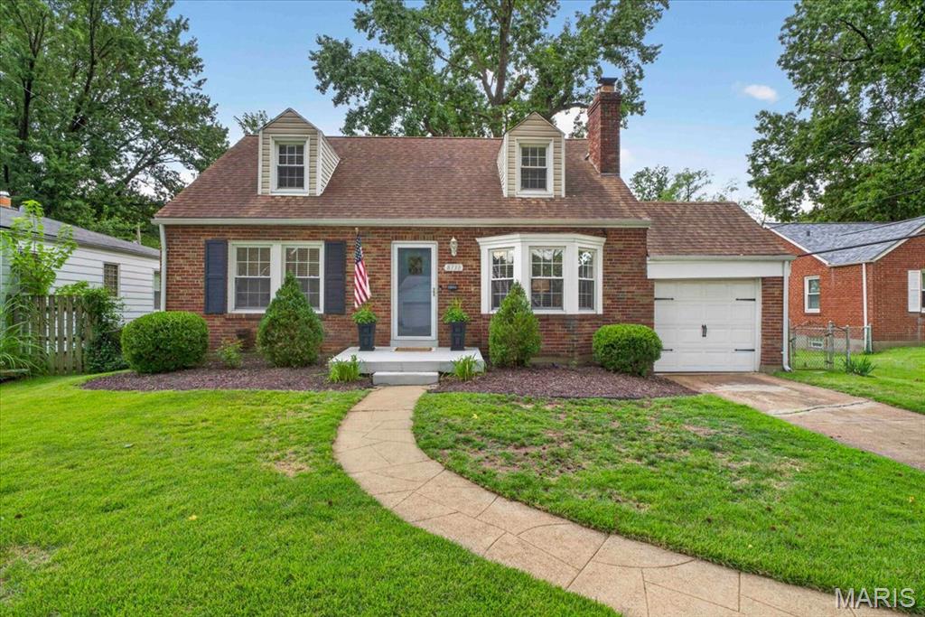 Welcome to 8738 Litzsinger Drive—a charming brick home offering an inviting blend of classic character, thoughtful updates, and flexible living space. Step inside to a bright living room featuring hardwood floors, a cozy fireplace, built-in shelving, and a large bay window that fills the space with natural light. The updated kitchen is both stylish and functional with gray cabinetry, quartz-style countertops, subway tile backsplash, stainless steel appliances, gas range, generous workspace, and a convenient breakfast bar. The adjoining dining room creates an easy flow for everyday living and entertaining. Just beyond the kitchen, a light-filled bonus area surrounded by windows offers the perfect spot for a breakfast room, home office, or additional sitting space. Two comfortable bedrooms and a full bath are located on the main level. Upstairs, the spacious primary suite feels like a private retreat with a vaulted ceiling, abundant room for furniture, and an impressive walk-in closet. The beautifully finished bath features a granite-topped vanity and a tiled walk-in shower with glass enclosure. The finished lower level adds even more usable living space with a large recreation room—ideal for movie nights, a game room, home gym, or entertaining—plus a separate laundry and utility area. Outside, enjoy a level, fenced backyard with plenty of green space and a patio ready for grilling, dining, and relaxing outdoors. An attached one-car garage adds everyday convenience. With its combination of hardwood floors, updated kitchen and baths, flexible bonus spaces, finished lower level, and welcoming outdoor areas, 8738 Litzsinger Drive is ready to impress!