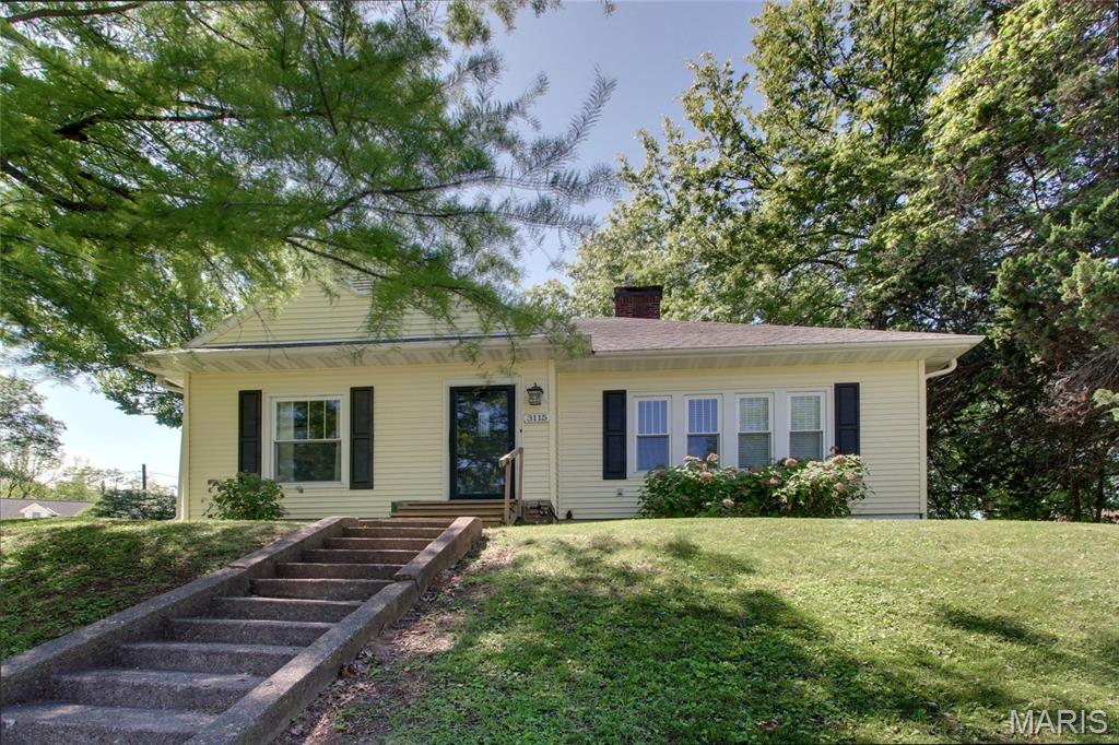 Welcome home to this absolutely darling cottage where vintage charm meets thoughtful modern updates. From the moment you arrive, you’ll be captivated by the inviting curb appeal, lush landscaping, and low-maintenance vinyl siding paired with 6” gutters and gutter guards for true peace of mind. Step inside to discover 1,388 square feet of warm, light-filled living space showcasing gorgeous original hardwood floors throughout the dining and living areas, and bonus: there’s hardwood hiding under the carpet in both bedrooms, just waiting to be revealed! 

The spacious 14x23 living room is anchored by a stunning fireplace, perfect for cozy evenings and gatherings with loved ones. Replacement windows flood every room with beautiful natural light. The kitchen comes fully equipped with all appliances including stove, refrigerator, dishwasher, and microwave making your move-in seamless. The adjacent dining room features rich hardwood floors that flow naturally throughout the main living spaces and a generous main floor laundry room (washer and dryer included!) adds everyday convenience. 

You’ll love the beautifully updated bathroom featuring a vintage-look tile design that perfectly complements the home’s classic character. Two comfortable bedrooms offer peaceful retreats at the end of the day. Downstairs, the unfinished poured walk-up basement provides a massive 1,262 square feet of potential, ideal for storage or workshop space. 

Outside the large lot truly shines with alley access, a detached 1-car garage, and an additional off-street parking slab for 2-3 more vehicles. A rare find! This one wont last, so schedule your showing today!