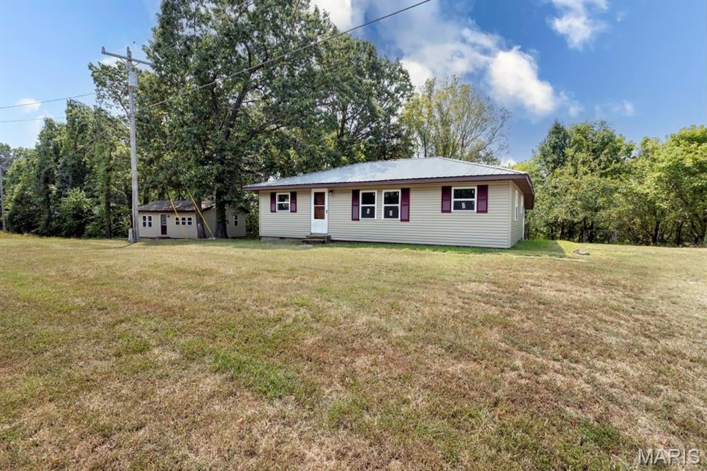 Calling all investors! This unique property offers two homes for the price of one on 1.82 acres, conveniently located near the front gates of Fort Leonard Wood. The larger home features 3 bedrooms and 1 bathroom, with one bedroom currently without a window, plus new siding, new windows, and a spacious utility room offering plenty of extra storage and functionality. The second home offers 2 bedrooms and 1 bathroom with a practical layout. Step inside to an open kitchen, living, and laundry area, with both bedrooms and the bathroom tucked just around the corner. Whether you're looking for a rental investment, multi-generational living, or the opportunity to live in one home while generating income from the other, this property offers plenty of possibilities!