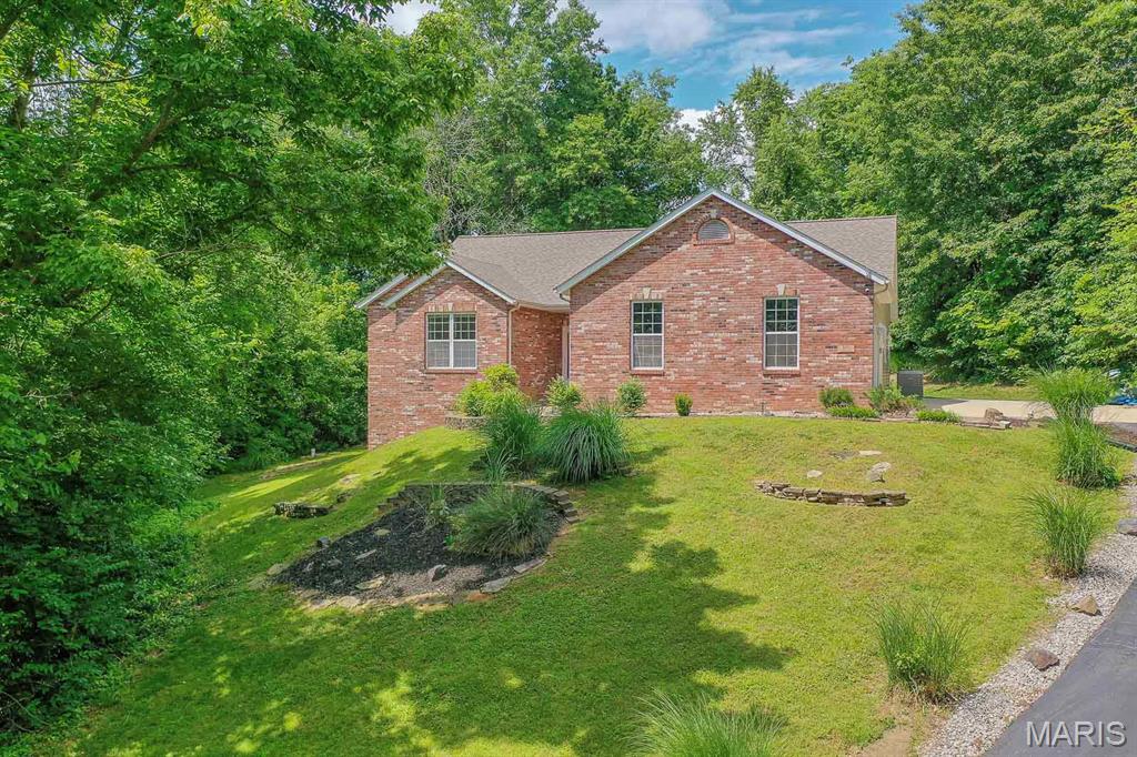 Showings start Friday, May 29th!! Tucked away on 2 private, wooded acres just minutes from downtown Edwardsville, this stunning ranch home offers the perfect blend of peaceful country living and everyday convenience. From the moment you arrive, you’ll fall in love with the serene setting, spacious layout, and beautifully updated finishes throughout.
Step inside to an open-concept floor plan featuring rich hardwood floors, abundant natural light, and inviting living spaces designed for both relaxing and entertaining. The remodeled primary suite is a true retreat with an updated ensuite bath, quartz countertops, luxury vinyl plank flooring, and a spacious walk-in closet.
The main level also features two additional bedrooms, updated guest bath, half bath and convenient main-floor laundry. The beautifully refreshed kitchen is ready for gatherings with new quartz countertops, a stylish hood vent, and gas cooking for the home chef.
Downstairs, the walkout lower level expands your living space with a massive family room, wet bar, full bath, two additional bedrooms, and plenty of storage — ideal for guests, hobbies, or multi-generational living. ***Walking Distance to the Madison County Trails...
Whether you’re enjoying quiet mornings surrounded by nature or entertaining friends and family, this home delivers the space, privacy, and lifestyle you’ve been searching for — all just minutes from shopping, dining, and everything Edwardsville has to offer.