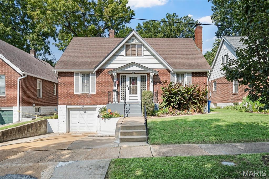 All-brick two-story in University City, offered for the first time in over 25 years. Features 1,383 sq ft above grade with 3 bedrooms, 2 baths, a full basement and a 1-car drive-in basement garage. Hardwood floors, a wood-burning brick fireplace, French doors and an arched entry into the separate dining room add original character. Eat-in kitchen with a window above the sink and bedrooms on both levels. The finished basement offers rec and hobby space, laundry, glass-block windows and interior garage access.  Level fenced yard with a concrete drive and mature trees. The interior is dated, with the kitchen, baths and finishes ready for cosmetic updates—and priced accordingly. Minutes from the Delmar Loop, WashU and Forest Park.