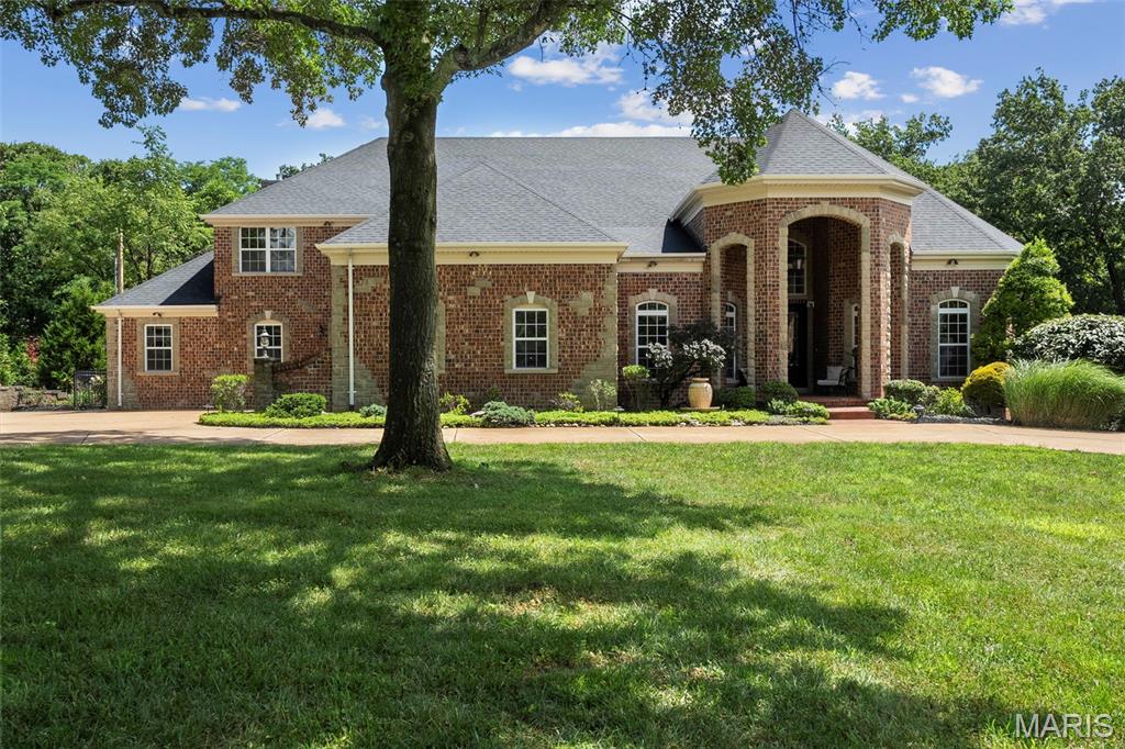 Welcome to 11 Summerhill Ln, an extraordinary custom-built home offering over 8k sq ft of refined living space. Nestled on a lush, acre-plus lot backing directly to Queeny Park, this all-brick masterpiece blends architectural grandeur with serene natural beauty. Step through the grand double doors into a soaring foyer with dramatic ceilings, marble flooring, and custom staircase. A breathtaking sightline draws your eye through the main living area to a wall of windows that perfectly frame the resort-style backyard. Flanking the entry are a home office and a formal dining room. The gourmet kitchen is a chef’s dream, seamlessly connecting to a sun-drenched breakfast nook and an inviting family room—perfect for both intimate evenings and large-scale entertaining. The main-floor primary suite is a private haven, complete with a sitting area, spa-inspired bath, and custom walk-in closet.  Upstairs, you’ll find four bedrooms, three full baths, and a loft-style media room—ideal for movie nights or a teen lounge. The finished lower level adds even more versatility, featuring a guest suite with ensuite bath and expansive open space for recreation, fitness, or a home theater.  The true showstopper lies outdoors: multi-level patios, professional landscaping, custom lighting, and an award-winning pool create a private resort atmosphere. With direct access to Queeny Park’s trails, you’ll enjoy unmatched privacy and a connection to nature. This is more than a home—it’s a lifestyle.