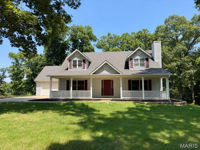 Enjoy the perfect blend of privacy and convenience in this spacious 1.5-story home, tucked away on 2.2 wooded acres in the Isaac Kent Farm community—just minutes from shopping and I-70. Offering more than 2,700 square feet of living space, this 4-bedroom, 3-bath home welcomes you with a dramatic two-story foyer and gleaming hardwood floors. The inviting great room features a cozy wood-burning fireplace with a circulating blower, creating the perfect gathering space. The well-appointed kitchen is designed for both everyday living and entertaining, complete with a center island, breakfast bar, stainless steel appliances, stone backsplash, gas stove, walk-in pantry and beautiful granite countertops. The main-level primary suite offers hardwood floors, a walk-in closet, and the convenience of main-floor living. Step outside to the spacious deck and unwind while overlooking the peaceful, wooded backyard, offering exceptional privacy and a serene natural setting. If you're looking for space, comfort, and a tranquil setting without sacrificing convenience, this home is a must-see.  Easy commute to Highway 70.