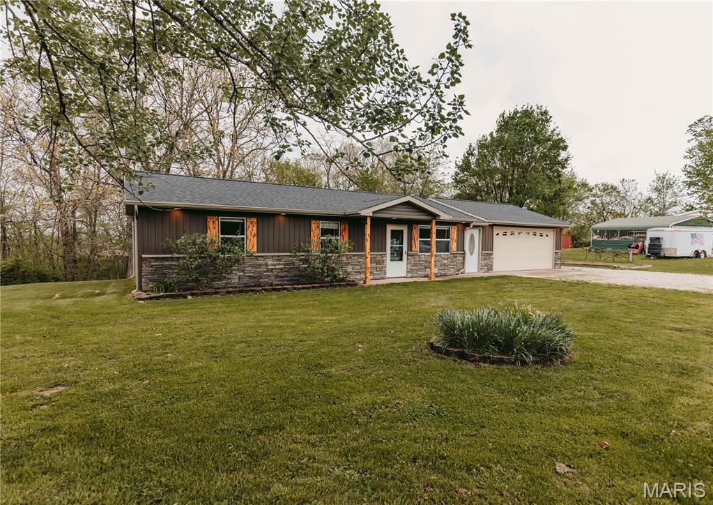 Country Feel Just Outside of Town! This well-maintained 3-bedroom, 1-bath home offers a convenient location, a spacious yard, wooded views, and numerous updates. Major improvements completed in 2024 include a new roof, siding, gutters, interior doors, fresh paint, and more! Inside, the home offers two separate living spaces, providing plenty of room to spread out or entertain. The family room features French doors opening to the back deck with views of the wooded surroundings. The centrally located kitchen connects the dining area, family room, and living room, while the traditional floor plan places all three bedrooms and the full bathroom together down the hall. A mudroom located just off the garage provides additional flexible space for storage, hobbies, or everyday organization. Outside, enjoy the deck, garden area, established blackberries, wooded views, and a nice-sized yard with a metal storage shed located behind the garage. Additional improvements and features include a family room addition, deck, mudroom, newer kitchen appliances, updated bathroom vanity and fixtures, updated lighting, carpeting, surround-sound wiring in the main living room, updated garage lighting, and a storm door at the front entrance. Located in the county just outside of town, this property combines a country setting with convenient access to nearby amenities. With multiple living spaces, outdoor features, substantial recent improvements, and room to enjoy both indoors and out, this home has plenty to offer!
