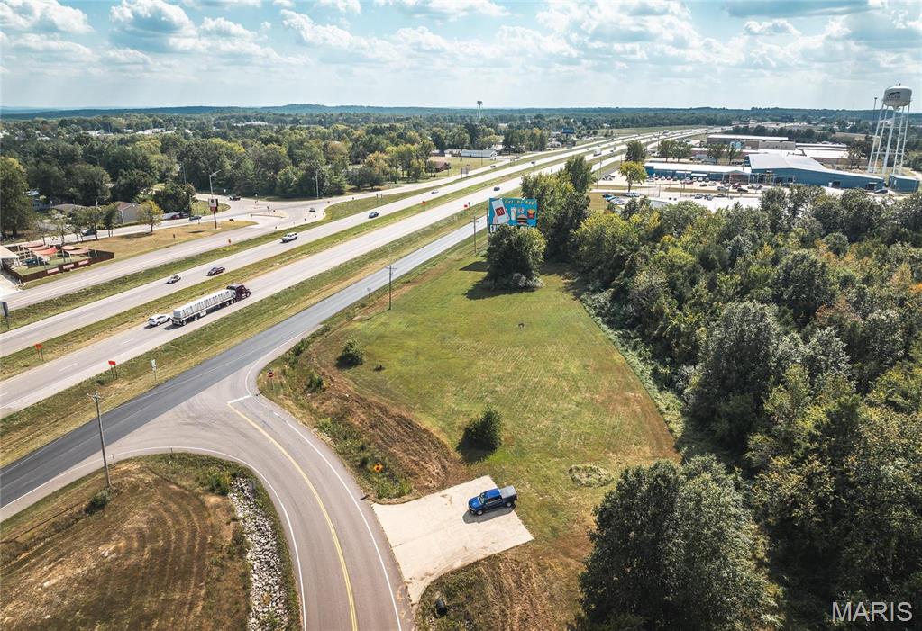 Interstate I-44 Exposure. 1.3 acres m/l of prime commerical property located just off of Sullivan Exit 225 near the Elmont overpass. This property has the benefit of the residential boom in Sullivan these past few years with continued residential building happening at a rapid pace.  The Elmont overpass was developed for the continued growth of Sullivan and the outlying areas to the north. This high traffic corner has an average daily traffic count of 31,000 from I-44 with 461' of road frontage. City utilities available. The traffic count is projected to reach a staggering 80,000+ by 2035. Take advantage of the boom in residential building, easy access, and I-44 access & exposure. Perfect location for a coffee shop, convenience store, gasoline station, retail operation, restaurant or automotive...just to name a few. Ideally located for maximum visibility and high traffic, it comes with the added advantage of an existing billboard lease, ensuring a steady stream of income. Location: City, High Traffic, Hwy/Interstate Frntg