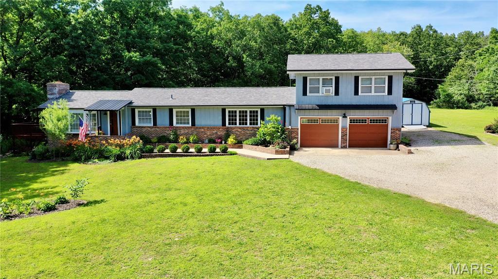 Great Location! Conveniently located between Rolla, Salem, and Fort Leonard Wood, this beautifully updated 4-bedroom, 2.5-bath home offers the perfect blend of comfort, privacy, and convenience on 22.49 acres. Inside, you'll find a formal living room featuring a fireplace, an inviting eat-in kitchen, and a spacious primary suite with a fully renovated bathroom and hidden walk-in closet. Recent updates within the last three years include new flooring throughout, fresh interior paint, stylish accent walls, updated plumbing and light fixtures, an architectural shingle roof, updated front siding, and a stunning kitchen complete with butcher block countertops, stainless steel appliances, center island with bar seating, and modern backsplash. The upstairs bedrooms each feature their own individual heating and cooling units, providing personalized comfort year-round. Step outside to enjoy the expansive deck, ideal for entertaining, relaxing, or enjoying your morning coffee while overlooking the beautifully landscaped yard filled with perennial flowers, mature landscaping, and a charming waterfall feature. A greenhouse/office offers endless possibilities for gardening, hobbies, or additional storage. The property also features a 24' x 26' detached garage/shop, storage shed, attached 2-car garage, and a partial unfinished basement for extra storage. The 22.49 acres offer an expansive lawn around the home and plenty of wooded ground to explore, hunt, or simply enjoy the peaceful country setting. Schedule a private showing today!