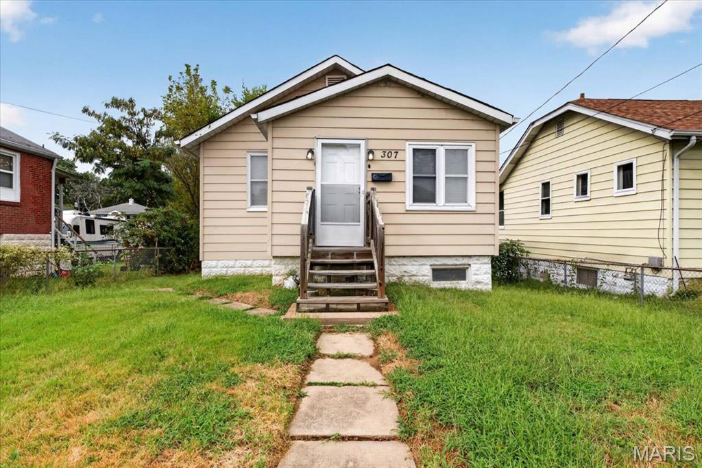 Welcome to this charming two-bedroom bungalow offering more space than meets the eye. The home features an inviting entryway with built-in storage, a comfortable living room, and an eat-in kitchen with oak cabinetry. The seller will leave all existing kitchen appliances, along with the washer and dryer. The walk-out basement provides plenty of additional storage. Outside, enjoy a spacious rear deck overlooking the fenced backyard, plus convenient off-street parking in the rear. This cozy home offers an excellent opportunity for an owner-occupant or investor. Schedule your showing today!