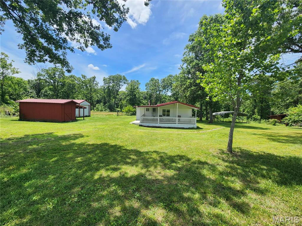 This roomie cottage & 50 acres has it all!  (2 parcels, 22.9 and 27 acres) There are two carports, a big front porch, an orchard, a fenced garden, a super nice chicken coup, and 2 equipment storage garages.  This property is close to I44 between Lebanon & Waynesville Missouri with wildlife galore and walkable to the Gasconade River access!  You've really got to see this one.  Just 1 minute of well-maintained county gravel road as you turn off the pavement and you are there, but it seems so private.  The 50 acres is really a private wildlife area with deer and turkey seen often.  For a tight budget, seller will consider splitting property.