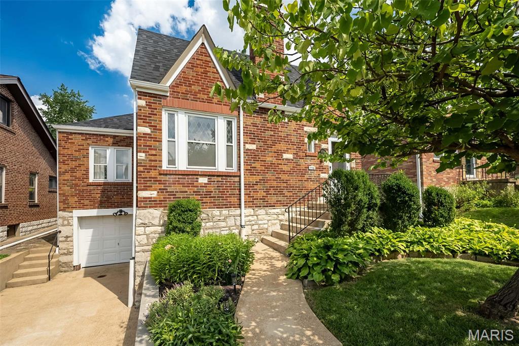 This attractive home has the perfect blend of charm and updates, plus the desirable Richmond Heights location! Lush landscaping and classic brick and stone exterior draw you inside to an entry foyer with a coat closet and lovely living room featuring gleaming hardwood floors, decorative stone fireplace and stained-glass windows. The large dining room is perfect for both family dinners and entertaining guests. If you somehow get tired of the of all the amazing restaurants nearby, the updated kitchen is one you will actually want to cook in. Lovely white cabinets, granite counter tops, subway tile backsplash, center island and stainless-steel appliances (fridge to stay!) Two generous bedrooms, one could be a wonderful office if needed. There is a full bath to round out main level. Upstairs is a true oasis awaits: huge bedroom, spacious walk in closet and gorgeous en-suite bath complete with double vanity and oversized shower. The basement includes a convenient tuck under garage and plenty of storage. The screen in porch is really a gem! You will enjoy sipping coffee in morning and relaxing at the end of the day. You will admire how pretty the private back yard is. This home has it all. To top it off the roof is only 1 year old.
