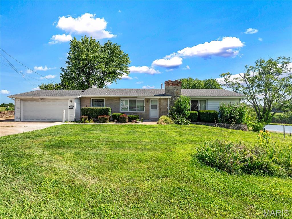 Step into timeless comfort with this classic, vintage-style ranch home nestled on just over 1 acre of serene land. Offering the effortless convenience of single-level living. This home offers unincorporated country living,  but is still close to all of the convenience that the wonderful town of Washington has to offer.

The heart of the home captures a nostalgic, welcoming warmth. Plenty of room to spread out and make it your own. Choose between main floor laundry, or the option for basement laundry connections that are already in place. 

Outside, the sprawling 1.1 acre lot provides a beautifully private setting perfect for summer barbecues, gardening, or simply enjoying the peaceful scenery. The spacious out building is perfect for a car or toy enthusiast, or would make a great work shop or man cave. It features tall ceilings and a wood burning stove. 

Need even more room? The massive unfinished basement is a blank slate ready for your imagination. Transform it into a custom game room, a home theater, or utilize it for extensive storage. Perfectly blending vintage appeal with future potential, this property is a rare find.