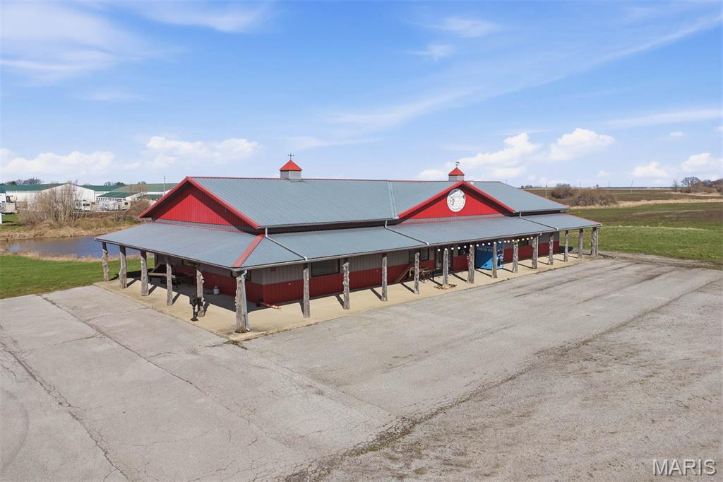 Endless possibilities in this 3,840 Sq Ft  commercial building zoned I-1 Industrial in Carlyle, IL  Great opportunity to start your own business or expand your existing business . The interior features a spacious showroom with built-in upper wall shelving, tiled flooring, ample fluorescent lighting, a private office, 1/2 bath, front counter area, and a utility space with manual bay door access. The building also offers a main front entrance and side emergency exit for added convenience.

Outside, you’ll find a partial wraparound covered concrete walkway, durable metal roof and siding, and paved asphalt and gravel parking areas along the front and side. The property also includes 220-amp electric service at the front of the building, plus an RV pad with additional 220-amp access and a clean-out drain. Situated on approximately 1 acre at a corner location with an average daily traffic count of 4,900± vehicles along IL-127, this property offers excellent visibility and accessibility. Conveniently located near established local and national businesses and just minutes from Carlyle Lake. Property sells As-Is.