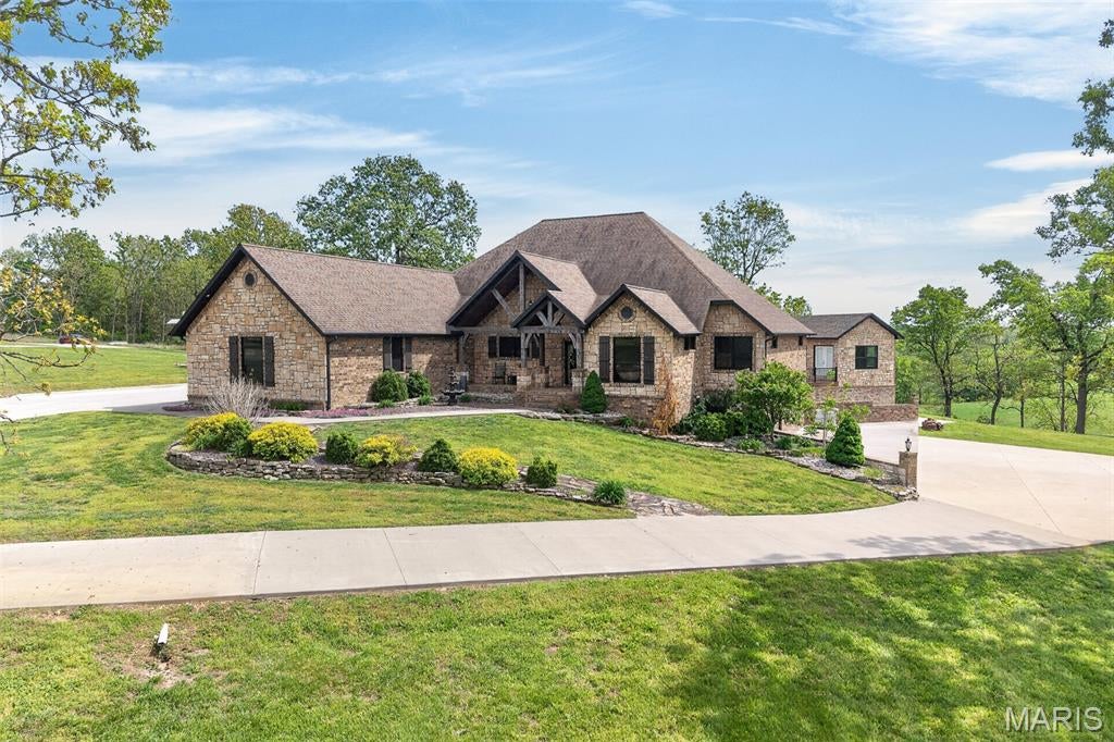 ABSOLUTELY STUNNING !! THIS is a ONE of A KIND PROPERTY and one of THE MOST BEAUTIFUL SETTINGS in THE AREA !!  THIS CUSTOM BUILT HOME is SETTING on 20 ACRES ml  with Large Scattered Trees and A POND.  A FULL BRICK & STONE HOME with fully finished WALK OUT BASEMENT, WONDERFUL VIEWS Of the valley Below. VERY OPEN CONCEPT LIVING and QUALITY IS THE WORD from The GROUND UP.  New IN-GROUND POOL in  2024, NEW POOL HOUSE JUST COMPLETED. NEW SHINGLES JUST INSTALLED.   This HOME HAS  OVER 5400 SQ FT ML OF FINISHED LIVING SPACE.  A 3 CAR ATTACHED GARAGE.  THE MAIN LEVEL OFFERS A LARGE LIVING ROOM with  FLOOR TO CEILING STONE FIREPLACE, Hardwood flooring throughout with Tile in The Baths ,  LARGE KITCHEN DINING AREA  and  CENTER ISLAND, GRANITE COUNTER TOPS  IN THE KITCHEN, LOWER BAR, AND ALL OF THE HOMES BATHS.  A GREAT ENTERTAINING AREA, REAR COVERED  PORCH, On the Main level you'll have, 3 BEDROOMS,  3 1/2 BATHS, A HOME OFFICE, DID I MENTION THE DOGGY SHOWER ROOM ? SPLIT BEDROOM PLAN, THE MASTER HAS A FIREPLACE, LARGE WALK IN CLOSET. ACCESS TO REAR VERANDA from your MASTER RETREAT. A LARGE BATH W/CUSTOM TILE SHOWERS  in ALLTHE MAIN LEVEL BATHROOMS, THE LOWER LEVEL OFFERS A HOME THEATRE AREA, VERY LARGE BAR, BEDROOM #4, with A FULL BATH, also, a 1/2 bath. W/urinal . A SAFE ROOM. THE LARGEST HOME SHOP IN THIS AREA OVER interior 10,000. SQ FT OF SHOP-with 2 LARGE OFFICES, FULL BATH, LAUNDRY  AREA,  POLISHED CONCRETE FLOORS, 14 FT OVER HEAD DOORS, COVERED PORCHES ALL AROUND,  PRIVATE ENTRANCE  with  SPLIT RAIL FENCING. MASSIVE CONCRETE DRIVEWAY leading to  THE PROPERTY, THE SHOP TOTALs 11,600 SQ FT INCLUDING the PORCHES w/ 2  HVAC SYSTEMS .  HOME HAS FULL HOME GENERATOR. Located Less than  5 minutes from the city. On a BACKOP ROAD. IF YOU WANT A FEW HEAD OF CATTLE OR A PLACE FOR THE HORSES  and A DREAM HOME ...MAKE YOUR APPOINTMENT TO VIEW this AMAZING Property !!
