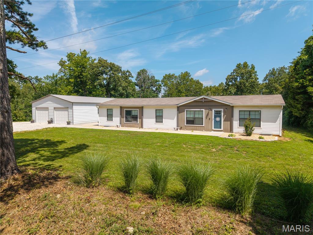 Located on a dead end county road in rural Perry County sits this 2021 built 4 bedroom, 2 bathroom home offering over 1,900 sq ft of living space, an open floor plan, and spacious bedrooms. Outside offers a detached 30x60 shop with concrete floors, 10 ft overhead doors with openers, and an additional 25x30 pole barn that has been converted into living space with a kitchenette, sleeping room, and a full bathroom with a tiled walk-in shower. All wrapped up on 8 secluded acres giving you plenty of room to get out and enjoy the outdoors.