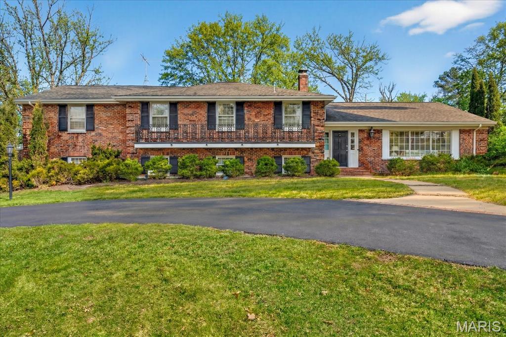 This five-bedroom, four-bath home is beautifully situated on a level 0.8-acre lot on a private cul-de-sac in Ladue. Offering three levels of generous living space, the home provides a remarkable opportunity to refresh and refine while enjoying its already impressive footprint. Warm wood floors anchor the main level, where generously proportioned rooms flow easily from one to the next. The light-filled kitchen is appointed with white cabinetry, a gas cooktop, double ovens, and a cheerful breakfast room that opens seamlessly to the patio and level backyard—creating an easy transition for indoor-outdoor gatherings. Formal living and dining rooms provide graceful settings for entertaining, while the inviting family room, centered around a striking stone fireplace and wet bar, offers a comfortable refuge. A spacious recreation room adds flexibility for play or hobbies. Upstairs, the ensuite primary bedroom is complete with an adjacent sitting room and ample space to personalize into a luxurious retreat. Three additional well-sized bedrooms and two full baths complete the upper level, assuring comfort and privacy for family and guests alike. A patio overlooking the expansive, level yard invites outdoor enjoyment, while a two-car attached garage and practical mudroom enhance everyday convenience. Situated within the highly regarded Ladue School District and in close proximity to several esteemed private schools, this property represents a rare opportunity to create a truly exceptional home in one of the area’s most coveted settings—ready and waiting for its next inspired chapter.