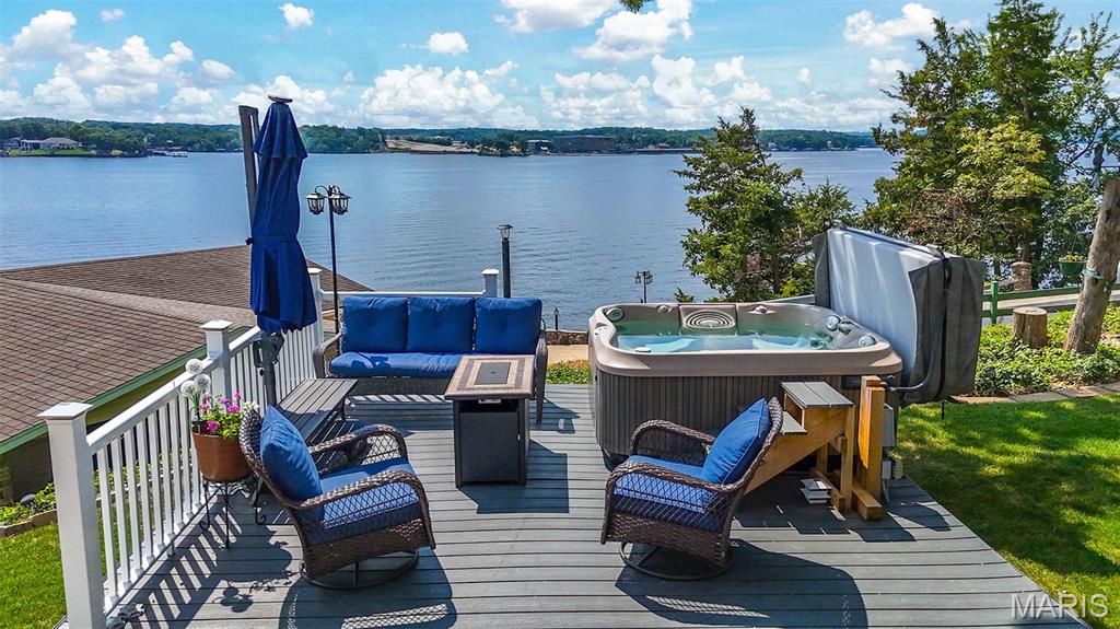 Some lakefront homes give you the view. This one gives you the view, the parking, the storage, the waterfront, and the space to truly enjoy it all.

Welcome to your next lakefront retreat, where breathtaking main-channel views, thoughtful updates, and everyday functionality come together in one exceptional property.

Imagine starting your morning with the lake in view, gathering with friends and family for a weekend on the water, and ending the day knowing there is plenty of room for everyone and everything that makes lake life fun. With 106 feet of lakefront on approximately .65 acres and panoramic water views from three sides of the home, the lake is a part of the experience from so many different vantage points.

The elevated setting captures those expansive main-channel views while still offering a gentle walk to the water. At the shoreline, an immaculately maintained dock that has been professionally serviced each year is ready for long lake days, quiet mornings by the water, and making the kind of memories that keep people coming back to the Lake year after year.

Inside, the home is move-in ready and designed with comfortable everyday living in mind. You’ll find 4 bedrooms, 2 bathrooms, multiple living spaces, an updated kitchen, fresh interior touches with some new flooring, and a sunroom with its own mini-split. Whether the sunroom becomes your morning coffee spot, a quiet place to read, or simply another space to sit back and take in the surroundings, it adds another way to enjoy this lakefront setting throughout the seasons.

Outside is where this property truly separates itself from so many other lake homes. A 3-car detached garage, 2-car attached carport, and abundant additional parking mean there is room for vehicles, guests, lake toys, trailers, and all the extras that come along with life at the Lake. Invite everyone over without wondering where they are going to park. Keep the toys close by. Have the storage and flexibility to actually use your lake property the way you imagined.

A durable metal roof and connection to community sewer add valuable peace of mind to an already thoughtfully maintained property.

And then there is the location. You are directly across the main channel from Shady Gators and Camden on the Lake, with Tap & Grill just around the corner. You can enjoy the energy and convenience of being close to some of the Lake’s most recognizable destinations, then come home to your own piece of paradise.

This is more than a home with a lake view. It is a property designed for actually living the lake lifestyle. Big-water views, 106 feet of shoreline, a beautifully cared-for dock, exceptional parking, serious garage space, lower-maintenance grounds, comfortable living spaces, and a location that puts you right in the middle of what makes Lake of the Ozarks special.

Thoughtfully maintained, move-in ready, and increasingly difficult to duplicate, this is the kind of lakefront property where you can arrive, settle in, and start making it yours. And there's one more thoughtul and special feature which will give you even more peace of mind. Call to find out more! Assumable VA Loan for Qualified Buyers!!!
