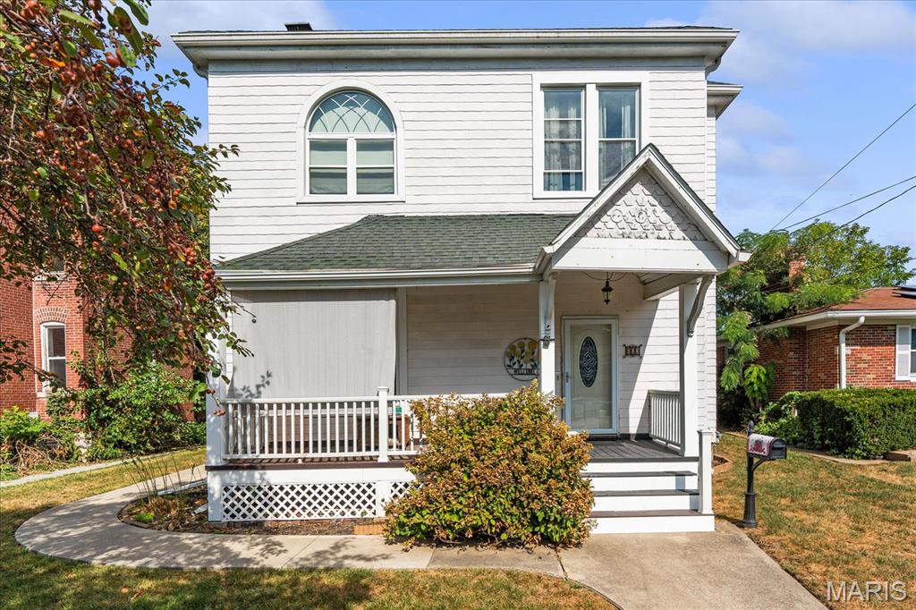 Wonderful spacious two story Victorian home with beautiful original open staircase, pocket doors, and so much more!  As you enter the front door you will be wowed by the beautiful staircase and antique fireplace in the foyer.  This area is great when welcoming guest and will be so much fun to decorate.  The living room has a gorgeous antique light fixture and a gas fireplace making it very cozy.  The original pocket doors lead you the the den or family room which is a great space for guest to relax before and after they have dinner in the formal dining room.  There is a bedroom off of the den which would also make a perfect office space.  The dining room has a beautiful original built-in cabinet, great for displaying all of your treasures.  You will notice original period doors, hardware, and woodwork throughout the home.  The updated kitchen has Silestone counters and all appliances stay.  There is off-kitchen access to the spacious fenced in backyard and the lower level.  The upper level hosts a huge landing along with three bedrooms, a full bath with clawfoot tub, and a laundry room.  One bedroom has a useable fireplace and French doors. There is a back staircase leading to the exterior. Updates include but not limited to: New boiler 2026, new water heater 2026, new windows with transferable warranty installed in 2020, new shingles and rubber roof in 2016, new 200amp breaker box 2007, and updated composite decking on the front porch. There is plenty of parking with a driveway up front, parking off the alley, plus a 2 car garage off the alley.  This home has so much to offer and is being sold as is.  All the big ticket items have been completed. Now it is the perfect time for you  to make this truly wonderful historical home your own.  Buyer will be responsible to bring home up to occupancy code after closing.  Buyer and buyer's agent to verify all information.