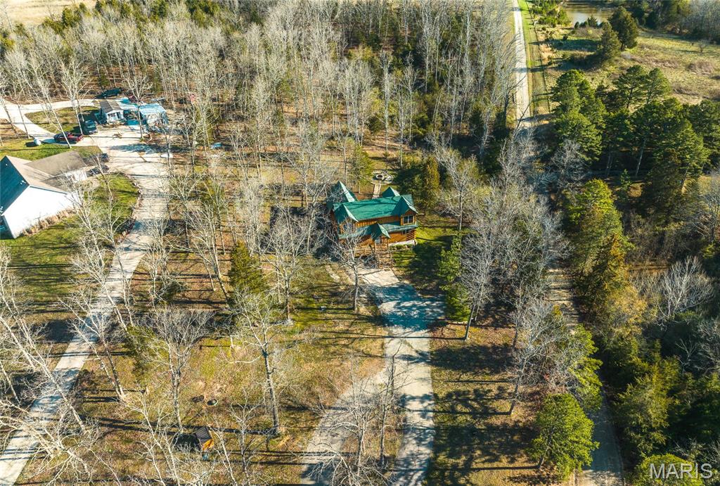 Nestled in the heart of the Missouri Ozarks near Cuba, this stunning custom log home offers the perfect blend of rustic charm, comfort, and outdoor adventure. Known as the floating capital of Missouri, Cuba places you just minutes from the crystal-clear Meramec River, Huzzah Creek, and Courtois Creek — making this an ideal retreat for floating, fishing, hiking, and enjoying the outdoors. Situated on 2.65 +/- acres, the property offers a peaceful and private setting surrounded by natural beauty. The spacious back patio is perfect for entertaining or unwinding after a day on the river, featuring a handcrafted log table and cozy fire pit where you can relax under the stars on cool Missouri evenings. Inside, the home showcases beautiful custom cabinetry, warm wood finishes, and the timeless character of authentic log construction. The fully furnished home is currently operating as a successful Airbnb, making it a true turnkey opportunity for investors, weekend getaway seekers, or anyone looking for a full-time escape in the Ozarks. Conveniently located near the Cuba Lakes Golf Course, this property combines recreation, relaxation, and income potential all in one incredible package. Whether you're searching for a private retreat, vacation rental investment, or forever home, this one-of-a-kind log home delivers the best of Missouri living.