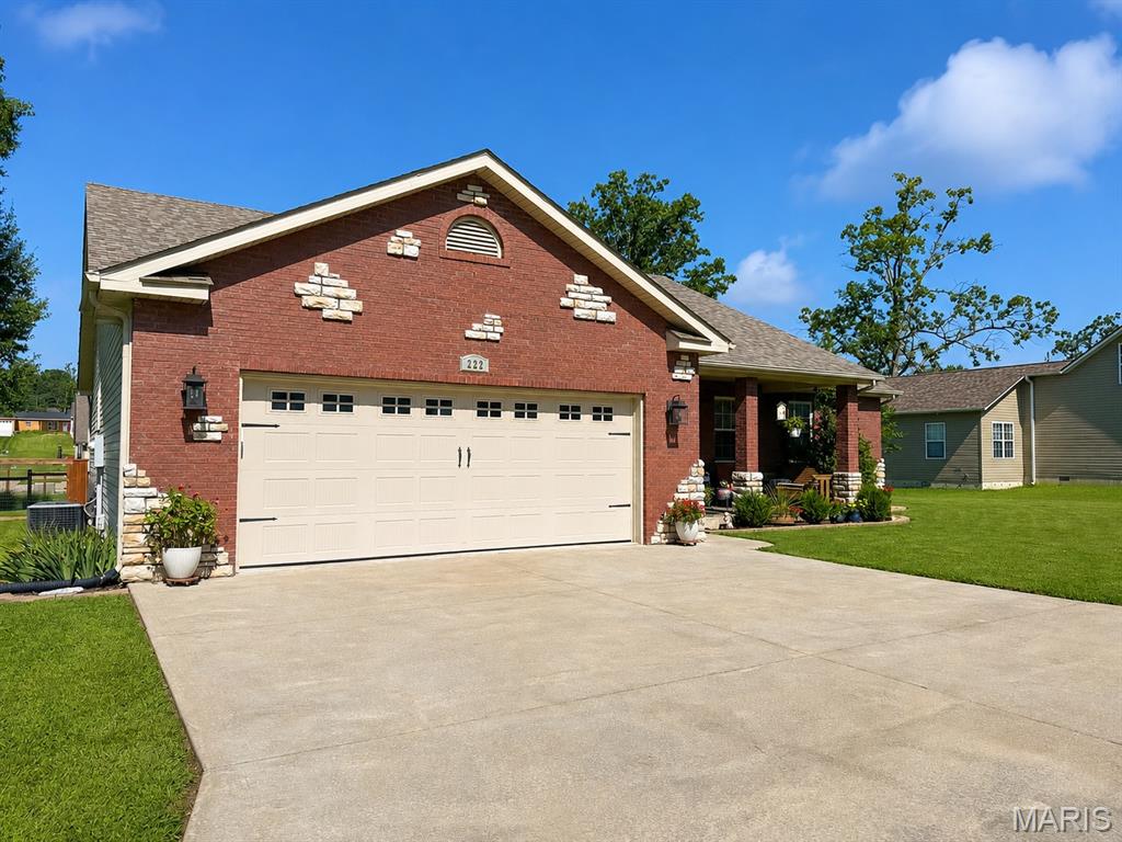 Welcome home to this beautifully maintained three bedroom, two bath home offering a comfortable layout and plenty of room to enjoy both indoors and out. The brick-front exterior, attractive landscaping, and spacious two-car garage create great curb appeal. Inside, you’ll find a bright, open living area with a tray ceiling, hardwood flooring, and plenty of natural light. The kitchen features wood cabinetry, stainless steel appliances, a large center island, and an adjoining dining area. The primary suite includes a large walk-in closet, double vanity, soaking tub, and separate tiled shower. Step outside to a covered deck overlooking the large fenced backyard, providing a wonderful space for relaxing, entertaining, gardening, or pets. This well-cared-for home combines style, function, and outdoor living in one inviting package.