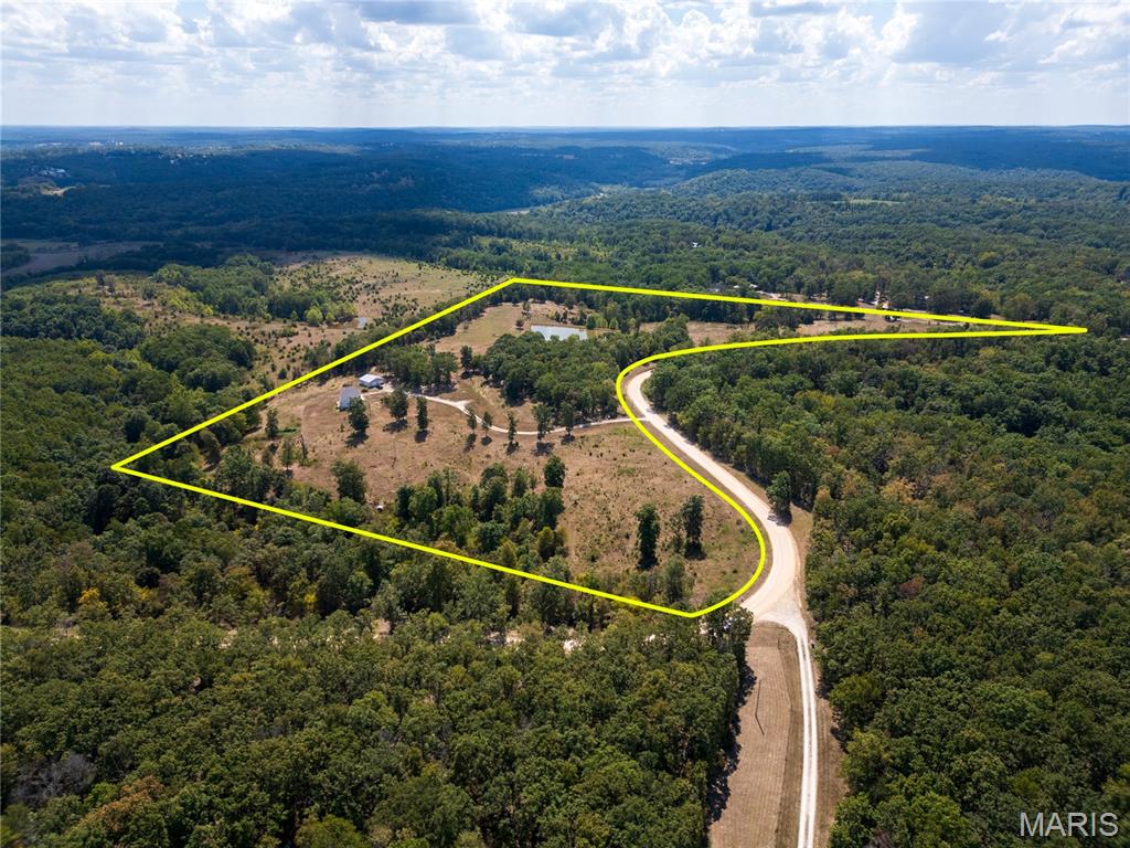 Your own private retreat on 24+ acres, a beautiful home, pasture, a pond, abundant wildlife, and room to live the lifestyle you’ve been dreaming about! This spacious 3-bedroom home offers plenty of room to spread out while giving you the privacy and freedom that only acreage can provide.
The spacious primary suite features a private bath with a separate tub and shower. The former 4th bedroom has been converted into additional dining space, creating an inviting area for family meals and gatherings.

Downstairs, the fully finished walk-out basement is made for entertaining, featuring an additional bedroom, full bathroom, wet bar, and spacious family area.

Outside is where this property truly shines! A huge 2-car detached garage/workshop provides plenty of room for vehicles, hobbies, projects, or storage. The fenced pasture is ready for cattle or other livestock, making this an excellent opportunity for the hobby farmer or anyone wanting room for animals. Enjoy fishing in the pond and keep your eyes open for the abundant wildlife.

Whether you're looking for space to raise livestock, entertain family and friends, enjoy the outdoors, or simply escape the hustle and bustle, this property offers an incredible opportunity to make the acreage lifestyle your reality.

Come see the possibilities for yourself—properties with this much land, privacy, and potential don't come along every day! Schedule your private showing today!