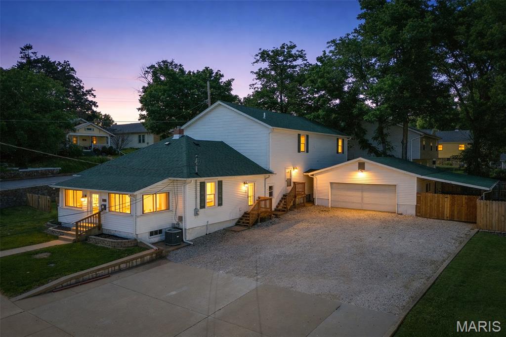 Welcome to this beautifully updated 1.5-story home offering 3 bedrooms, 2.5 baths, and situated on two spacious lots in the highly desirable Festus R-VI School District!

This inviting property offers the perfect blend of charm, space, and functionality with numerous recent updates throughout, including fresh interior paint, a brand-new roof, newly replaced porch steps, and new fencing along the back of the property for added privacy and peace of mind.

The expansive main-floor primary suite is a standout feature, complete with French doors that open to a large covered porch on the Ridge Avenue side, creating the perfect private retreat for morning coffee or relaxing evenings. The ensuite bath offers exceptional storage with two walk-in closets.

Upstairs, you’ll find two generously sized bedrooms, each featuring large walk-in closets and connected by a convenient Jack-and-Jill bathroom, along with a spacious upper-level family room that offers endless possibilities as a second living area, game room, or media space.

The main level also features a flexible bonus room just off the kitchen, ideal for a formal dining room, home office, playroom, or additional sitting area. The adjoining main-floor laundry and mudroom area, complete with a utility sink and convenient 1/2 bath adds everyday ease and functionality.

Step outside and enjoy multiple outdoor living spaces, including a fenced concrete patio area beside the garage featuring a lean-to, fire pit, and storage shed—perfect for entertaining, relaxing, or enjoying evenings outdoors. The fenced side yards provide even more usable outdoor space for pets, play, or gardening.

The detached 2-car garage with its own half bath is an incredible bonus, offering added convenience for guests, hobbies, or workshop use.

Additional bonus: the newly installed stop sign at Central and Ridge has greatly slowed traffic, enhancing the appeal of this corner location.

With space, updates, flexible living areas, and fantastic outdoor features, this home is a must-see and offers exceptional value in a sought-after location!