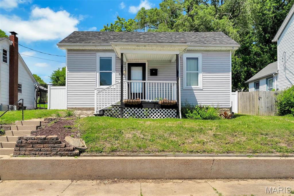 Absolutely a dollhouse right here just a few blocks from the Riverfront, walking trails, restaurants, parks, pool, athletic fields, and more! This home has newer flooring, a big nice kitchen with built ins, Sunporch with main floor laundry and more. Fresh paint is neutral, it features a big privacy fence, AND a 2 car garage entering from the back off the alley. Turn the pets and kiddos loose here in backyard. This payment will beat paying rent any day, move in ready and already ready! Passed occupancy inspection.