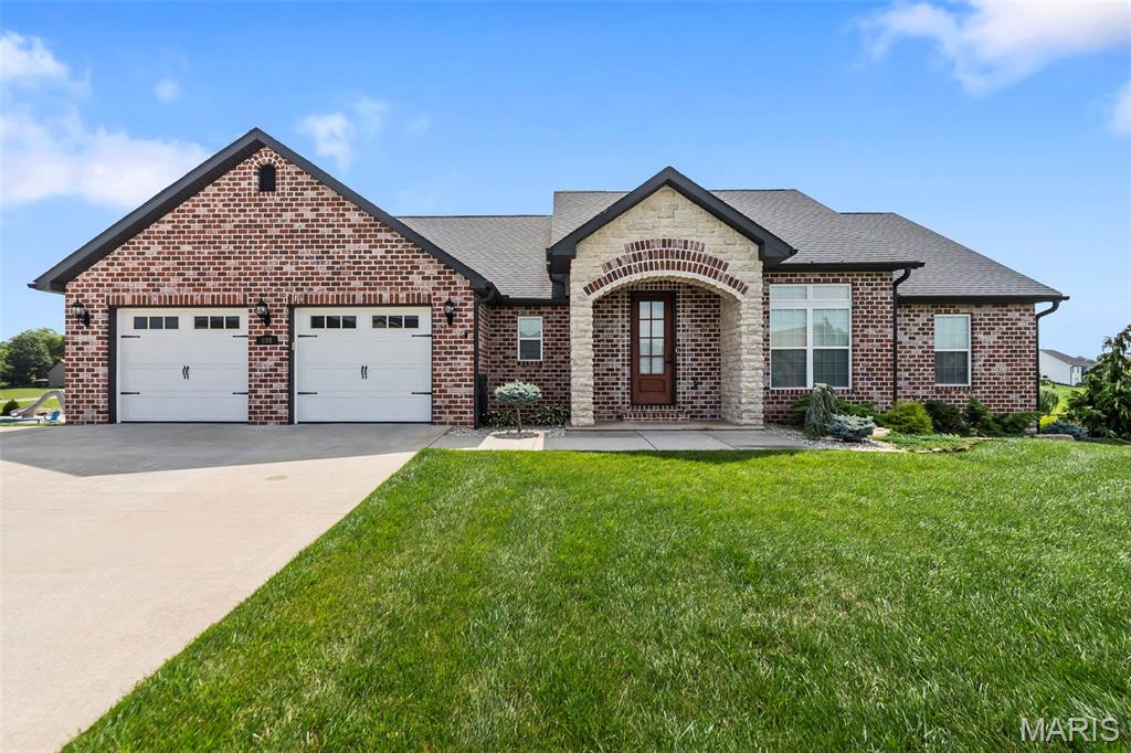 Stunning lakefront home built in 2019 featuring 4 bedrooms, 3 bathrooms and exceptional curb appeal with a beautiful stone and brick front exterior. Enjoy breathtaking scenic lake views and direct water access with your own private dock. The thoughtfully designed open floor plan offers a spacious main-level primary suite complete with walk-in closets, dual vanities, a soaking tub and separate shower. Convenient main-level laundry adds to the home's functionality. The kitchen showcases beautiful cabinetry, granite countertops and flows seamlessly into the large living room highlighted by impressive coffered ceilings. The expansive walkout basement features high ceilings, a stunning stone gas fireplace, abundant storage space and a John Deere room. Whether relaxing indoors or taking in the picturesque waterfront setting, this home offers the perfect blend of comfort, space, and lakefront living.