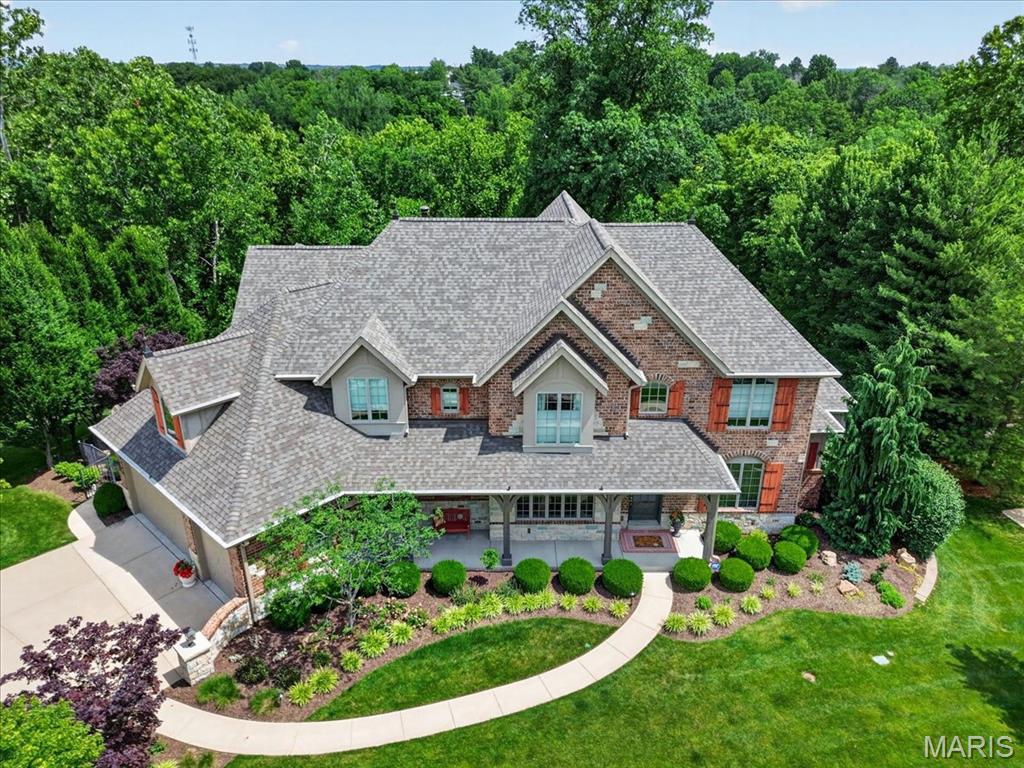 Spectacular Flower built home, situated on a beautiful lot in the coveted Wilson Creek subdivision. This extraordinary 6900 sq/ft  1.5 story boasts four bedrooms and 7 baths.  Enjoy sitting in your private fenced yard enjoying your hot tub and cozy stone fireplace. This elegant home offers unmatched features and amenities. As you enter you are greeted with gleaming hardwood floors and a  2 story entry foyer. The spacious kitchen and hearth room offer hardwood floors, vaulted ceilings, granite countertops, 42 inch cabinets and both a walk in pantry & laundry room. The spacious main floor primary bedroom has 2 walk in closets and a recently totally renovated luxury bath! All 3 additional upstairs bedrooms are ensuite bedrooms with private baths and an additional loft/office/play area. The incredible finished lower level is the place for entertaining! A full wet bar/kitchen area with wine rack, refrigerator, entertainment theater area and 1.5 baths. The lower level also includes 3 walk outs, a gym/workout room with mirrored walls and rubber gym flooring. Additional amenities include a gorgeous composite deck, exterior stone fireplace with wood storage and gas starter, multi zoned sprinkler system, Generac back up generator, exterior BBQ grill area off the hearth room, newer architectural shingle roof (2024) , updated Zoned HVAC (2022) with an air scrubber system. All Flower homes have beautiful unique designs with outstanding finishes. A fabulous location just off Wilson and Wildhorse Creek offers easy access to the Hwy and all of the Chesterfield amenities.