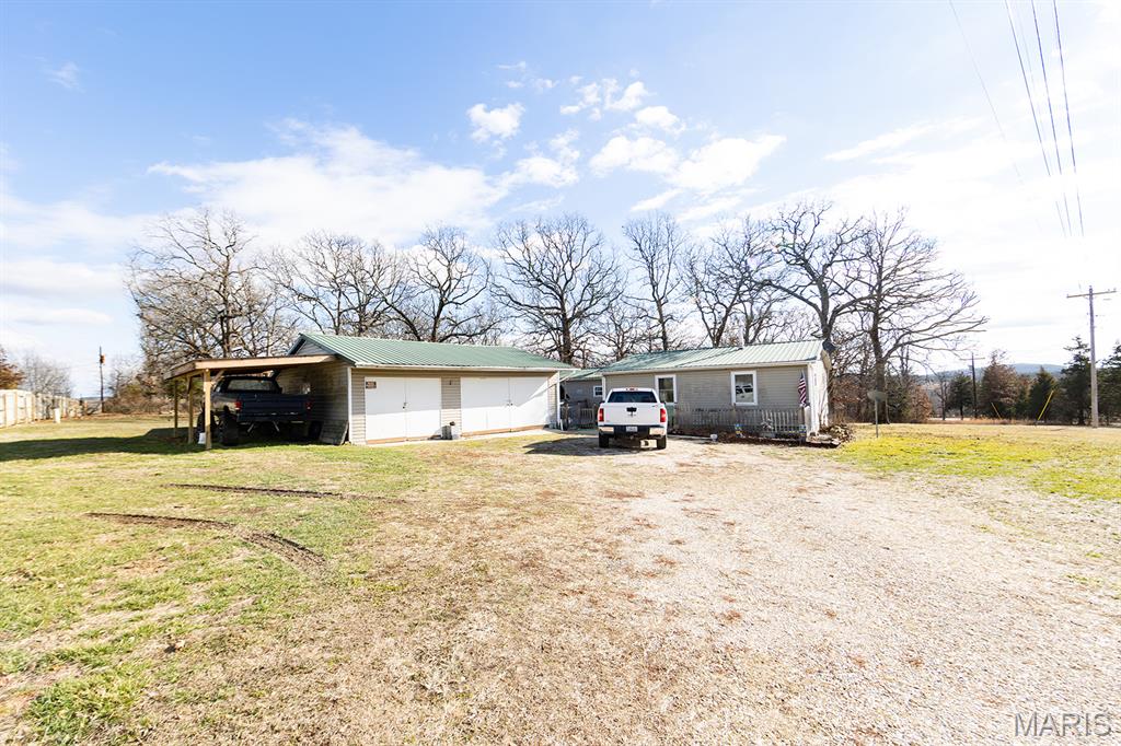 Welcome to this spacious 4-bedroom + 2-bath home, situated on 1.84 +/- acres! This property offers the perfect blend of affordability, convenience, and space...featuring a large 2-car garage/shop, multiple deck areas for entertaining or relaxing, and a fenced backyard ready for pets!
Inside, you’ll find all one level living, a kitchen offering plenty of cabinet storage, along with a pantry for extra organization and functionality, a spacious living room, and comfortable bedrooms. 
Enjoy the convenience of having Dollar General right next door, while outdoor recreation is only minutes away with Lane Springs and Little Piney Creek nearby. Plus, commuting is easy with a straight shot into town on Highway 63! Call today to see it in person!