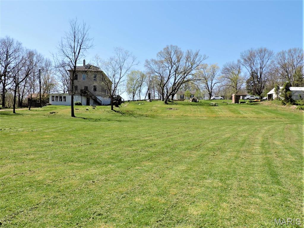 This historic pre-civil war building includes 1.6 acres along the "Big River" about 45 minutes southwest of St Louis. The building has undergone an extensive renovation over the past few years & awaits a new owner to reach it's full potential. A popular destination for a day trip, camping, fishing, boating ,swimming  or spoil yourself with a private room. With 6 private bedrooms, over 3800 feet of finished space on 2 floors with a full walk out basement with rough-in service for 2 baths & 2nd kitchen,8' ceiling height.
Loads of green space for garden, kids, pets & access to the Big River. River views from 2nd floor. Walk to state park over foot bridge . House is perched up on a hill. This property also includes a 1500 square foot metal building with 200 amp electric service, drive in door, work shop ,separate well source and storage racks. The buildings aren't in flood zone. (www.morsemillhotel.com) check it out!! Location: Corner Location, come take a look.
