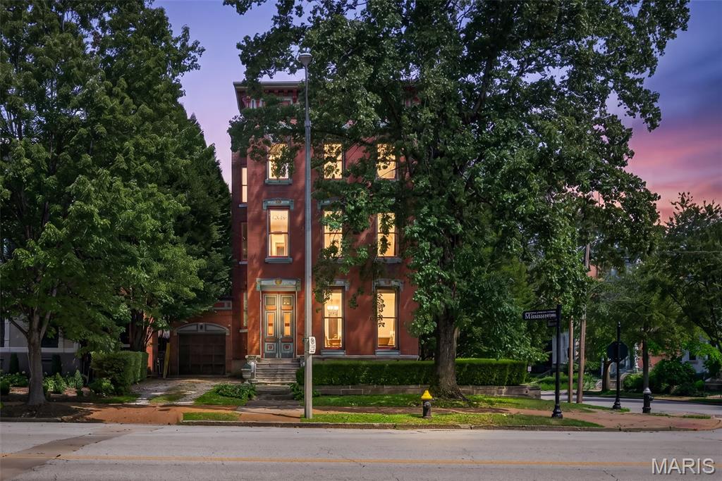 Welcome to 1554 Mississippi Avenue, where timeless Lafayette Square architecture meets exceptional modern luxury. Perfectly positioned in one of St. Louis' most iconic and historic neighborhoods, this extraordinary residence offers an unmatched combination of craftsmanship, elegance, and contemporary comfort just steps from beautiful Lafayette Park, acclaimed restaurants, and vibrant city living. The heart of the home is an absolutely stunning chef's kitchen designed to impress. A breathtaking coffered ceiling creates an unforgettable focal point, while the oversized center island with generous seating becomes the natural gathering place for family and guests alike. Beautiful stone countertops, designer pendant lighting, premium finishes, and abundant workspace make this kitchen as functional as it is spectacular. Enjoy large format tile floors, an impressive custom range hood, white cabinets with crown, a sleek, integrated wine refrigerator, an in-wall oven and microwave and a Wolf 6 burner gas stove. Just beyond, a newly refaced maintenance-free deck extends your living space outdoors, creating the perfect setting for morning coffee, grilling, or entertaining. The luxurious primary suite is a true private retreat. The spa-inspired ensuite bath features an oversized walk-in shower wrapped in floor-to-ceiling tile, a built-in bench, dual body jets with a rainhead shower system, a double adult-height vanity topped with marble, a private water closet, and a separate jetted soaking tub for ultimate relaxation. Completing the suite is an enormous custom walk-in closet with the convenience of an integrated laundry area. The third level offers an incredible flex space with panoramic views of the Gateway Arch and the downtown St. Louis skyline. Whether you envision a private fitness studio, executive home office, media lounge, or creative retreat, this versatile room adapts perfectly to your lifestyle while showcasing unforgettable city views. Throughout the home, historic character blends seamlessly with today's luxury finishes, creating an inviting atmosphere that is both sophisticated and comfortable. Every space has been thoughtfully designed for effortless entertaining and everyday living.
Living in Lafayette Square means enjoying one of St. Louis' most celebrated historic neighborhoods, with tree-lined streets, beautifully restored Victorian homes, Lafayette Park, boutique shopping, restaurants, coffee shops, and easy access to downtown, major hospitals, and the city's top attractions.
This is more than a home—it's an opportunity to own a remarkable piece of St. Louis history while enjoying every modern luxury today's discerning buyer expects.