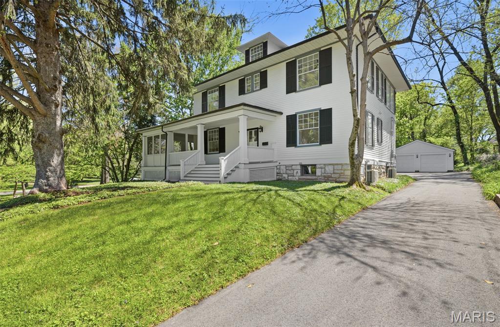 Set in the heart of Historic Webster Groves, this iconic 1899 two and a half story residence has been meticulously reimagined to offer a seamless blend of timeless character and sophisticated modern living. Featuring 5 bedrooms, 4.5 baths, and extensive updates throughout, the home showcases preserved architectural detail alongside elevated finishes and thoughtfully integrated systems—an exceptional opportunity in one of the area’s most sought-after settings.
Inside, expansive, light-filled living spaces are designed to accommodate both elegant entertaining and comfortable daily living. Original elements, including pocket doors, add warmth and character, while refined updates enhance functionality throughout. The main level includes a large living room and a versatile den, ideal for a private office or additional living space.
The kitchen serves as a stunning focal point, with a high-end gas range, dual ovens, stainless steel appliances, drawer microwave, and an oversized island with double-sided seating and abundant storage. A formal dining room provides a sophisticated setting for gatherings, while the screened-in porch extends living outdoors with ease.
The second level is anchored by a luxurious primary suite designed as a private retreat. The spa-inspired bathroom features a marble walk-in shower, soaking tub, and upscale finishes. A sunlit, window-lined master closet offers both beauty and function. The conveniently located laundry, two additional bedrooms, and an exquisite full bath complete the second level.
The third floor offers two additional bedrooms and a connected full bath, providing flexible space for guests, teens, children, or extended family.
The finished lower level further enhances the home with a spacious rec room, full bath, a generous storage room, and potential for a future walk-out configuration.
Outdoors, the property offers a private, park-like setting with a level, tree-lined yard designed for both relaxation and entertaining. The screened-in porch creates a seamless transition to the outdoors, ideal for morning coffee or evening gatherings, while the expansive yard provides ample space for play, gardening, or future enhancements. Mature landscaping and natural privacy elevate the serene atmosphere, and the mostly fenced yard adds both function and peace of mind. A detached 2-car garage completes the exterior, offering convenience and additional storage.
Notable improvements include refinished original hardwood flooring throughout, new carpeting, new roof and gutters, updated electrical and plumbing, and a dual HVAC system—with separate zones for the main living areas and upper levels—ensuring year-round comfort and efficiency.
Ideally located in Webster Groves, this home offers convenient access to parks, walking and biking trails, local restaurants, boutique shopping, and vibrant community events, as well as nearby entertainment and recreation options.
Luxury, character, and an unbeatable location—this is a truly exceptional home in Webster Groves. Schedule your private showing today.