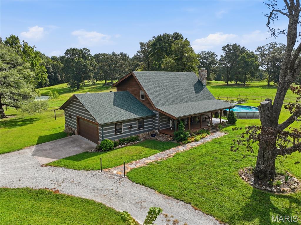 Nestled within 5 miles from Norfork Lake and easily accessible off a paved highway, this 33 acres horse ranch offers the perfect balance of seclusion and productivity. Welcome to Wildest Dreams Ranch. The beautifully built authentic log home, has been updated and remodeled to include granite counter tops, custom knotty alder cabinets a jetted tub and tile shower.. There are 2 master suites, one on the main level and one upstairs. The partially finished walkout basement has an additional 2 bedrooms and a full bathroom. Beautiful hardwood floors and high beamed ceilings accent the open upper level that overlooks a beautiful rock fireplace with insert.The property boost a 4 stall horse barn, a 30x40 garage with 220 electric, an equipment shed, tack/grain room with heat and air and a hay barn. The fields are gently rolling, fenced and cross fenced with 2 ponds, an automatic waterer and working corrals. Outside for your recreational enjoyment, there is an above ground pool with a deck, covered front and back porches to have your morning coffee and a beautiful view of the ranch. Lastly there is an established garden spot, and 3 RV hookups with water hydrates nearby. Log home, land, barns, outbuildings, seclusion and easy accessibility: your perfect ranch ready for your family awaits.