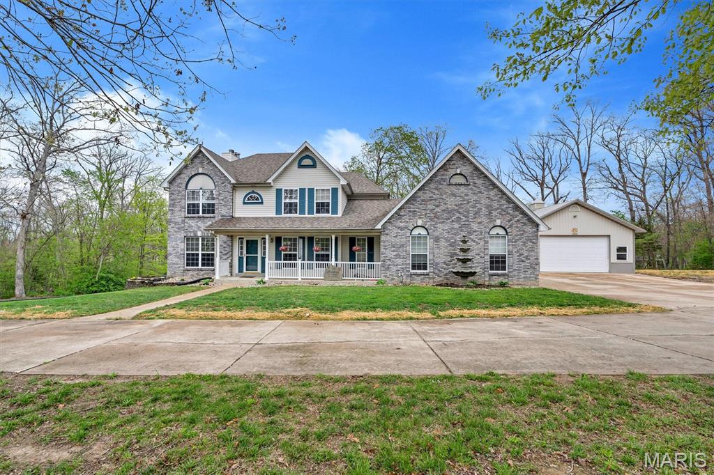 Tucked away on 3 peaceful acres in the desirable White Oak Trails subdivision, this beautifully updated and meticulously cared-for 4-bed, 3-bath traditional two-story offers the perfect blend of privacy, space, and modern comfort. The main level features a formal dining room, office, and a spacious family room with a gas fireplace and porcelain flooring. The kitchen and breakfast room flow together seamlessly, offering an open, welcoming layout ideal for everyday living, and include one of the home’s two Pella sliding doors—the second located in the walk-out basement. All kitchen appliances stay, and the home is equipped with a 3-stage water filtration system and water softener for added convenience.  DECK AND PATIO TO BE ADDED.

Upstairs, you’ll find four generously sized bedrooms, including a primary suite with a walk-in closet and an updated bath. The walk-out lower level provides a massive unfinished space with 9-ft pour, egress window, roughed-in bath, and a wood-burning furnace, giving you both future expansion potential and an efficient supplemental heat source.

Outside, the property shines with a private, park-like setting, mature trees, and bright, colorful flowers that add charm and warmth as you approach. The impressive 30×40 outbuilding is exceptionally well-insulated—including the ceiling—and features a wood-burning stove plus a new Bosch mini-split system offering heat pump, AC, and dehumidification. Whether you need a workshop, hobby space, or climate-controlled storage, this setup is ready for anything. The oversized garage configuration at the home adds even more flexibility. With wooded surroundings and the peaceful feel of country living paired with the convenience of Francis Howell schools, this home truly has it all.

Negotiable.  Seller willing to add patio and deck.