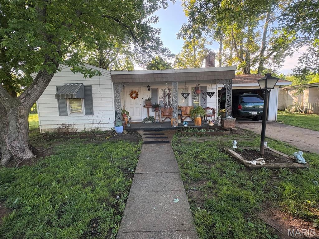 Cute 1950's bungalow with charming front porch, fireplace, and back patio.  This well-maintained 3 bedroom 1 and half bath offers a warm and inviting layout.  The back bedroom has the half bath within and the 2 other bedrooms are split with bath in the middle. Also included is a sunroom that could be used as a small home office or playroom.  This home features plenty of natural light throughout, a convenient carport/garage (needs door) and shed. New central air and furnace in last couple of years as well.  Looking to increase your rental portfolio? First home? Downsizing?  This ones for you!!