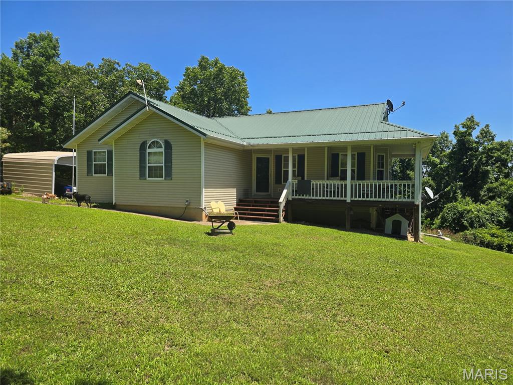 ESCAPE to the peace and privacy of country living with this spacious home situated on 12.15 beautiful acres.  Offering 4 possibly 5 bedrooms and 3 full bathrooms this property provides plenty of room for a growing family, multi-generational living or those needing extra space for hobbies or guests.  Close to the east gate of Fort Leonard Wood and inbetween Rolla and St Robert this is the ideal location.  The versatile floor plan features 1 or 2 bedrooms on the main level and 3 bedrooms downstairs creating flexible living arrangements. Convenience is unmatched with 2 separate laundry rooms to help make everyday living easier! Outside you'll fall in love with the gently rolling acreage offering a picturesque setting with plenty of room to roam, garden or simply enjoy. For those needing work space or storage the property includes a shop, extra one car garage, carports and additional room for equipment, tools and recreational vehicles. Whether you are looking for a hobby farm, private retreat or a spacious home with acreage this property offers endless possibilities with an amazing setting.  Don't miss the opportunity to make this slice of country paradise your next home!