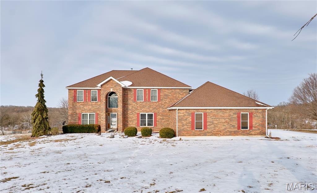 ONLY 7 miles from 1400 +/- acres of Bridlespur Hunt Club, incredible area to ride your horses!  Custom built 2-story home on 10.64 acres with three fenced pastures and huge 4 stall horse Morton barn and another small shed-Master bedroom suite on the main floor, master bath features garden tub, separate shower and dual sinks-Main floor includes open eat in country kitchen with 42" oak cabinets, Silestone counter tops, huge breakfast bar, walk in pantry and walks out to covered deck-Great rm boasts cathedral ceilings and wood insert fireplace. Formal dining has beautiful hardwood flooring. Upper level includes 3 bedrooms and loft that overlooks the great rm on the main floor. Jack and Jill bath between 2 of the bedrooms and the 3rd has its own private bath. Lower level walkout is mostly finished with lots of room for entertainment and recreation also has full bath and an exercise room. Lots of room in the 3-car oversized garage with work area. Great location 30 min from Wentzville!!-newer windows installed approx 8 years ago