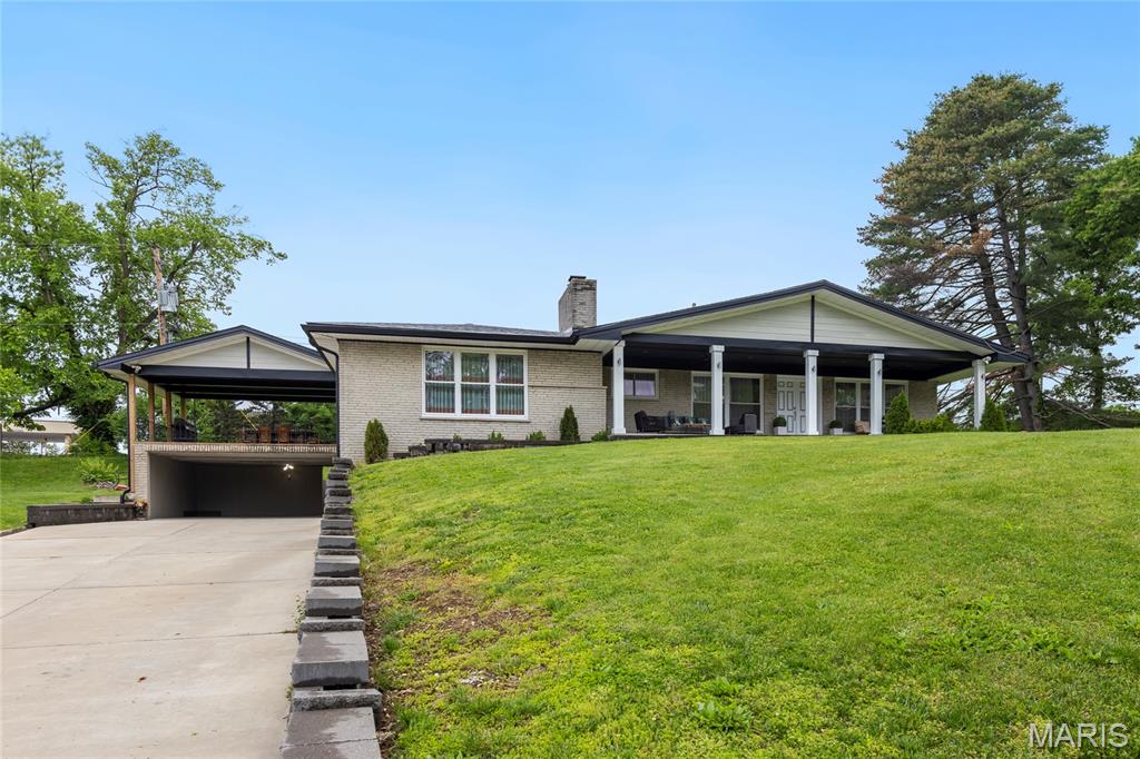 Beautifully maintained and updated brick ranch in the highly sought-after Sunset Hills community, within the award-winning Lindbergh School District. The inviting main level features a spacious family room with a charming brick-surround fireplace, seamlessly flowing into an open-concept kitchen and breakfast area. The kitchen is appointed with marble countertops, rich cherry cabinetry and modern stainless steel appliances all with neutral finishes. An additional generously sized family room offers versatile living space and provides direct access to a covered patio-perfect for outdoor entertaining, overlooking the level backyard. The main floor includes four well-appointed bedrooms and two full bathrooms. The finished lower level expands the living space with a sleeping area, full kitchen, full bathroom, a large custom laundry room and abundant storage. Additional highlights include a private backyard lined with mature trees and exceptional parking, with garage and covered driveway space for up to four cars. At the end of a quiet cul-de-sac come move right in!