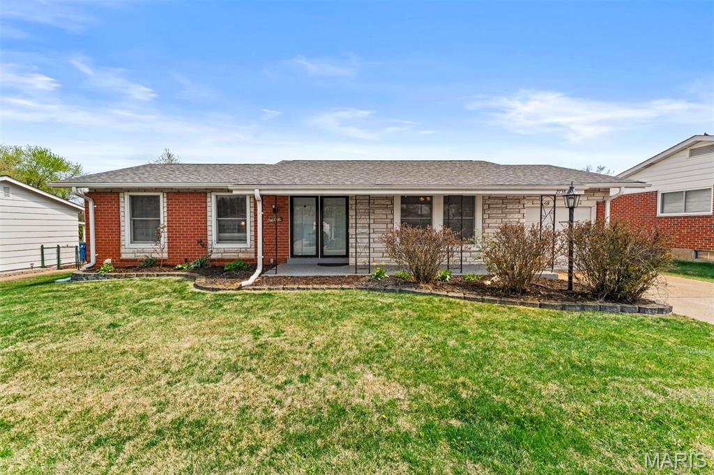 This exceptional low-maintenance brick and stone home makes a lasting impression from the moment you arrive, with the meticulously curated landscaping and striking curb appeal. A spacious front porch welcomes friends and family into a bright foyer, flanked by a large living room filled with natural light. Newer laminate flooring leads you into the expansive, fully updated kitchen (2020), featuring modern cabinetry, updated flooring, stylish lighting, backsplash, and stainless steel appliances—perfect for entertaining or everyday living. A newer sliding door opens to a large covered patio overlooking a fenced backyard with stunning landscaping, creating an ideal space for relaxing or hosting BBQs. The home features a comfortable primary suite with a private bath, along with additional bedrooms and a fully updated guest bath. Wood flooring throughout these spaces adds warmth and charm. Meticulously maintained and truly move-in ready, this home also includes a newer architectural roof (2019), a new HVAC, a newer water heater, and a sump pump for added peace of mind.
