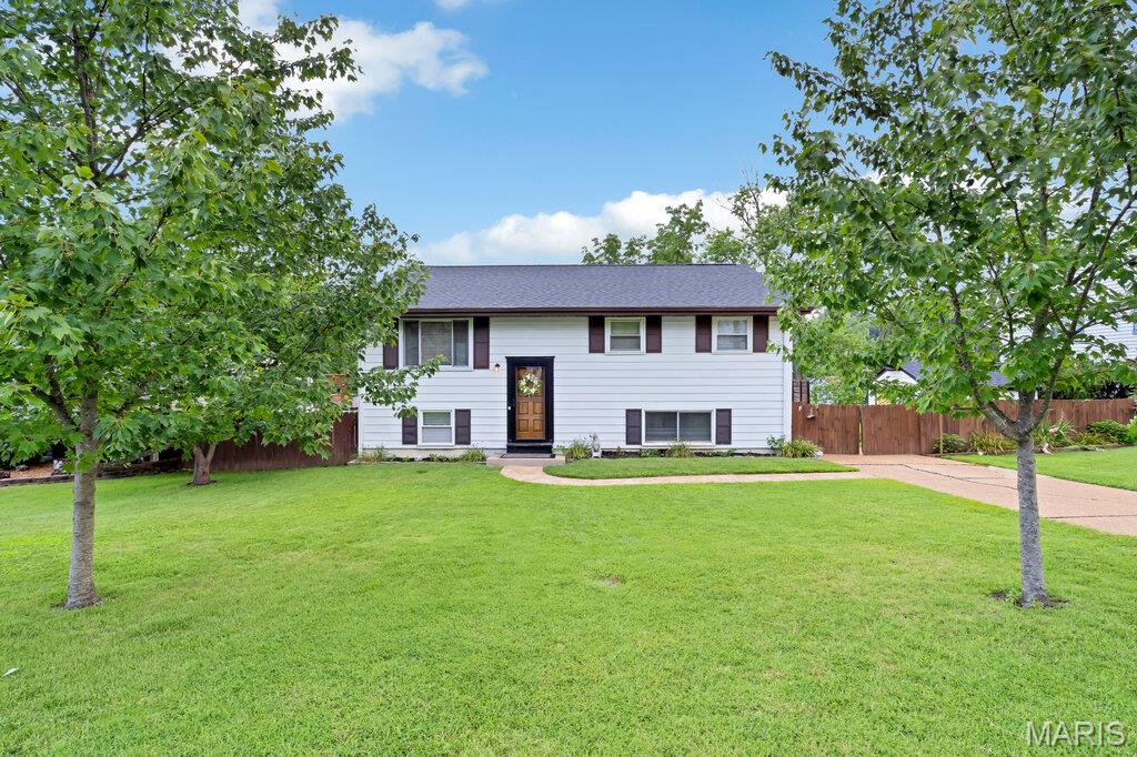 Welcome home to this charming 4-bedroom, 2-bathroom home, lovingly maintained by its original owner. Full of character and quality craftsmanship, this well-cared-for home offers solid bones, beautiful custom updates, and the perfect opportunity to add your own personal touch. Conveniently located with easy highway access, you'll also enjoy being just minutes from a variety of restaurants, shopping, and entertainment. The kitchen features stainless steel appliances installed in 2022, while the main level showcases beautiful original hardwood floors that extend up the staircase. Throughout the home, custom-built closet doors and barn doors, add timeless character and craftmanship. The renovated primary suite provides a relaxing retreat with newer laminate flooring, a granite-top vanity, an extra-deep soaking tub/shower combination, subway tiling, and a frosted privacy window.  Major mechanical updates offer added peace of mind, including a roof installed in 2021, an approximately 3-year-old air conditioner, and an approximately 6-year-old furnace. The finished lower level expands the living space with a fourth bedroom and a full bathroom that has been renovated with laminate flooring and a subway tiled walk-in shower, making it ideal for guests, a home office, or a private living area. Outside, you'll find an oversized patio, a spacious deck with low-maintenance vinyl railings and spindles, and a storage shed for all your outdoor needs. Combining thoughtful updates, timeless features, and an unbeatable value, this home is priced to sell. Don't miss your opportunity—schedule your private showing today!