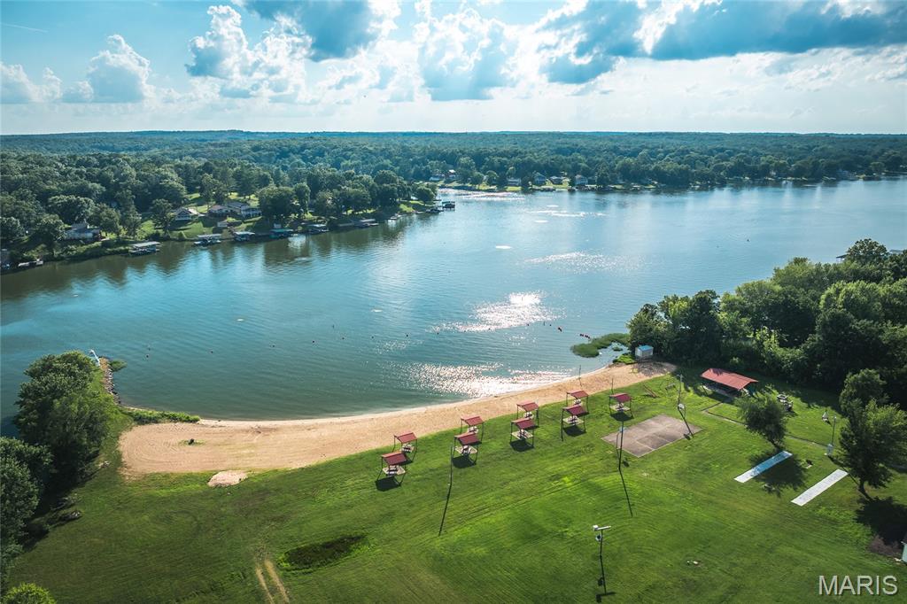 This lot is located in a gated community with a 326 acre (+/-) lake. Build your dream home, a weekend cabin or just use for access to enjoy the lake and community amenities. Spend your summer days boating, fishing, skiing, tubing and swimming. There is a sandy beach with pavilions, a playground and basketball court. The pickleball/tennis courts have been recently updated. There are several locations around the lake to launch your boat and day-use docks are available to members. Community events include poker runs, bingo nights, trivia nights, beach party with DJ and lots of other ways to have a great time at the lake year round. Seller is negotiable on paying off road assessment for the buyer at closing with the right offer. Build your cozy cabin or just use the lot for lake access and all the great activities of the community! Don't let this one get away.