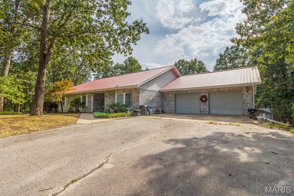 Rockwood Estates Is where this unique "One of a Kind " home is located.  Everything on One Level .....No stairs to get inside front door and no interior stairs.  This 3 Bedroom home is PERFECT....One Owner that has maintained every inch of their home.  Lots of updates you must see !!!  There is engineered Hardwood installed in all common areas.  The  Large open floor plan with a beautiful Custom Gourmet Kitchen that was totally remodeled in .  Quartz countertops 5 burner LP cooktop, 700cfm Range Hood vented to the outdoors....Nice big living room, separate dining room and Eat In Kitchen with a large back deck off the breakfast nook.  All 3 bedrooms are larger then most other local homes.  Did  I mention the oversized attached garage that makes  a great " Man Cave".   This pretty spatial home sits on over 1 acre of land...the Lot is flat and perfect place to put in a pool,  kids outdoor activities....possible a tree house....only your imagination limits the possibilities.  The  Big back Deck was also renovated with Tre Decking and New Rails ...Off the deck is perfect He Shed/ She Shed... nearly 150 Sf with slab on grade flooring.  the shed dimensions are 12x16 with an additional 6x16 covered mower storage.  This home is located about 10 minutes from the front gate of Fort Leonard Wood. ... 5 minutes from shopping and local eateries in St Robert MO...Waynesville RVI school district.    This Beautiful home has 100% Wheel Chair Compliance for the full home,....Wide door ways....Roll in shower...heated bathroom floor...Truly a " One o A Kind" home !!